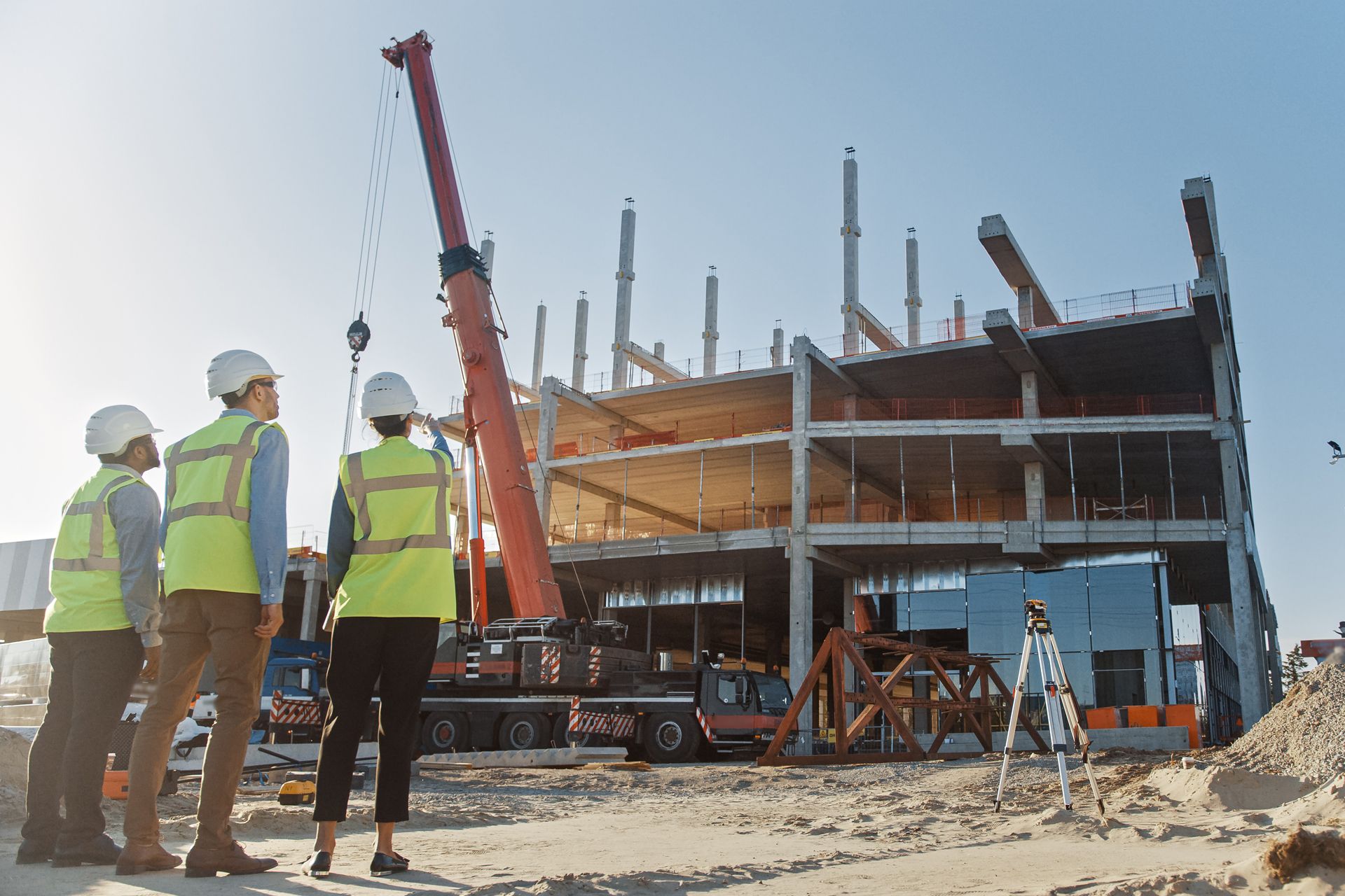 A Group of Construction Workers Are Standing in Front of a Building Under Construction
