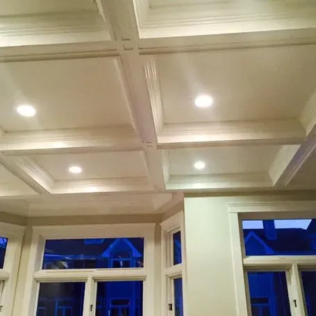 A Living Room With a Coffered Ceiling and Lots of Windows