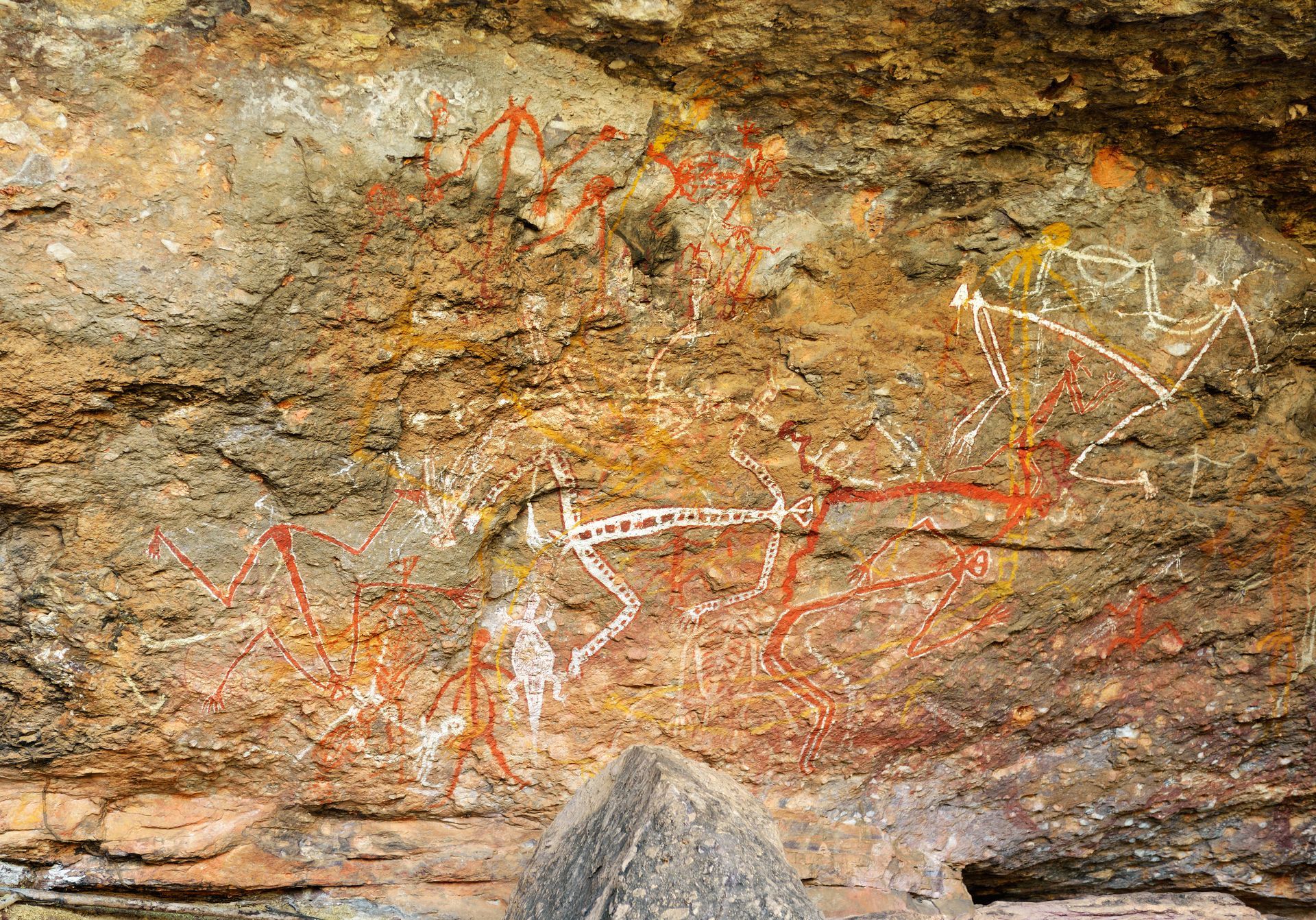 A close up of a painting on a rock wall.