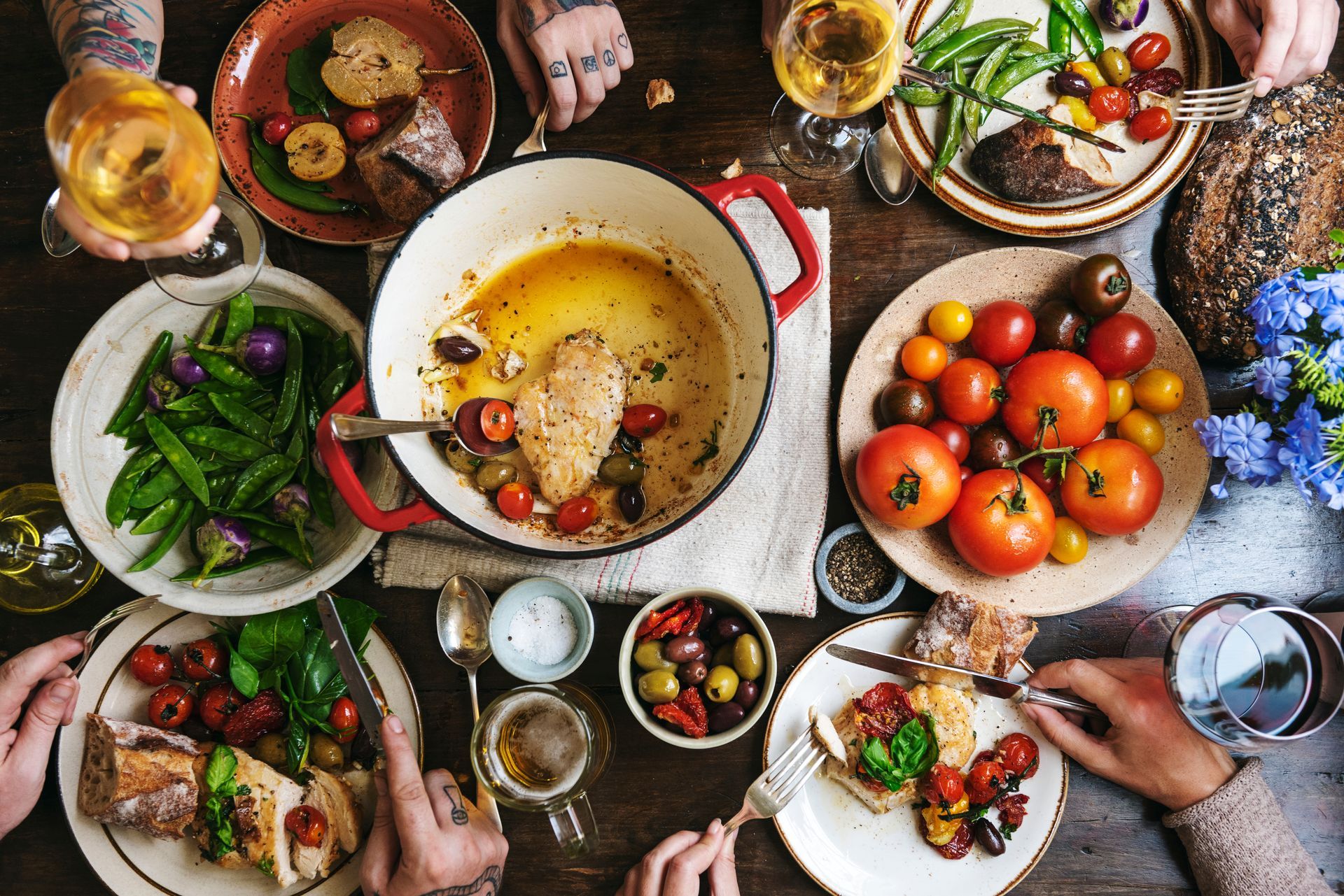 A group of people are sitting at a table with plates of food.