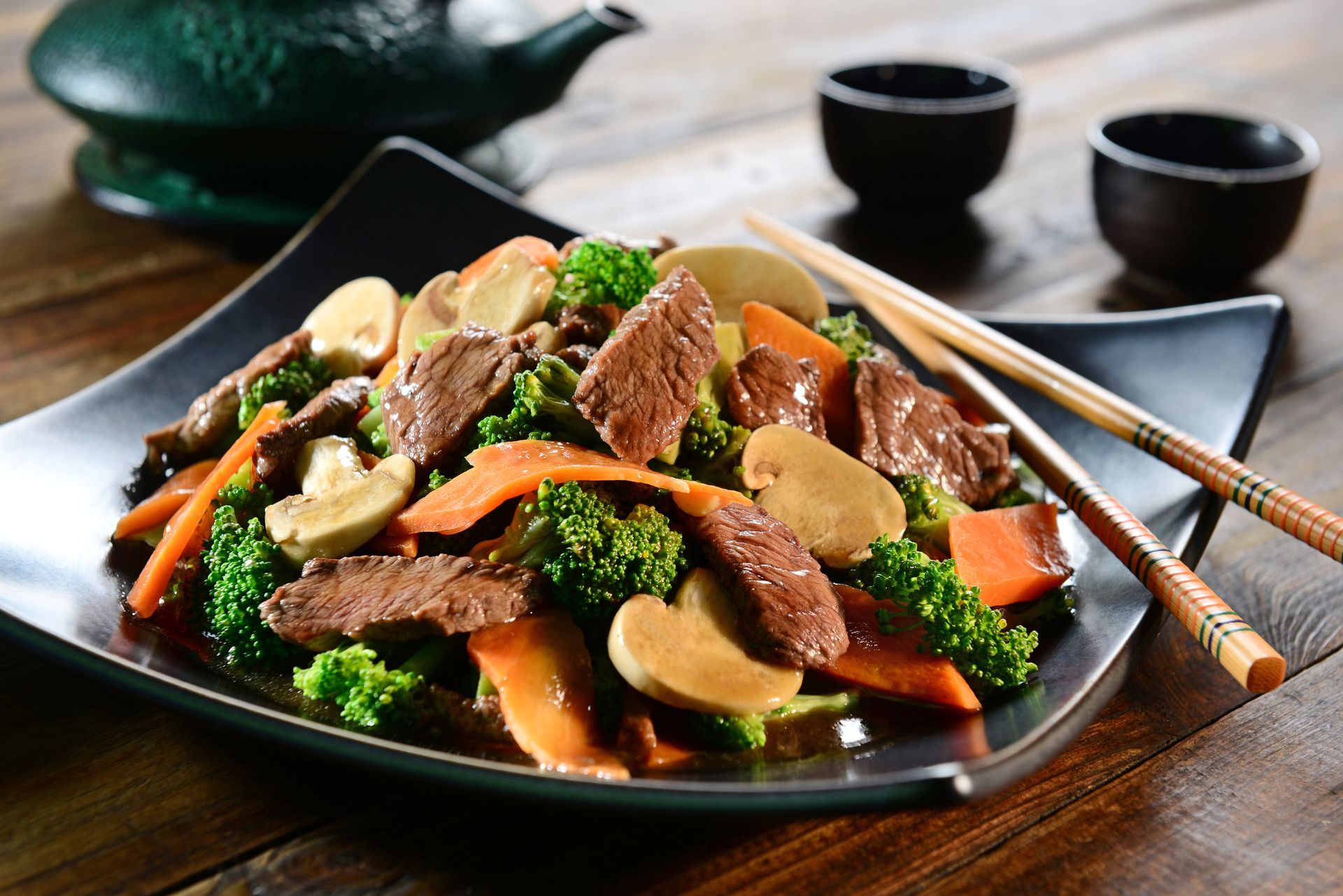 A sunset over a mountain range with a lot of fog