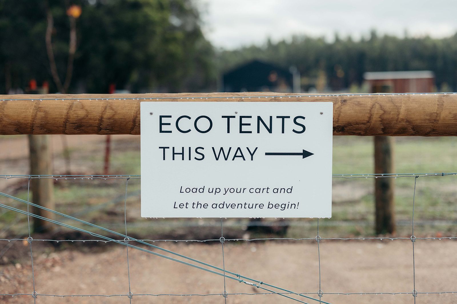 Sign on a fence reads 