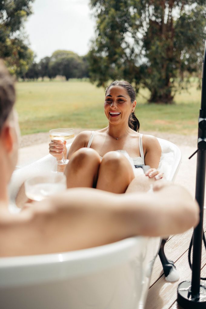 A tent is sitting in the middle of a field surrounded by trees.
