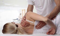 Massaging woman's back — Chiropractic Care in Fort lauderdale, FL
