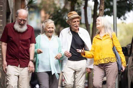 a group of older people are posing for a picture together