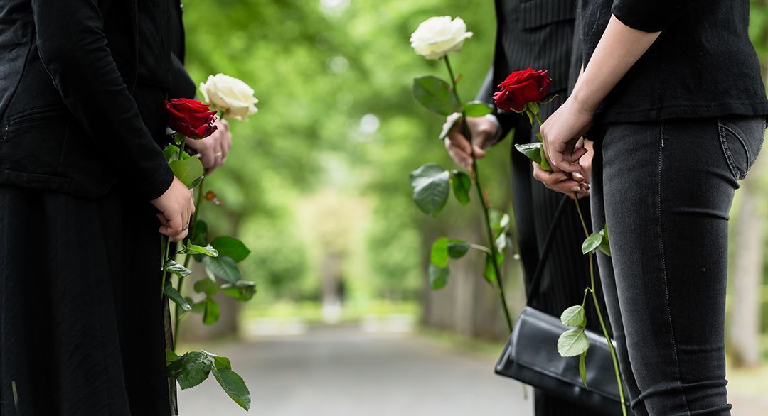 two rows of people facing each other holding roses