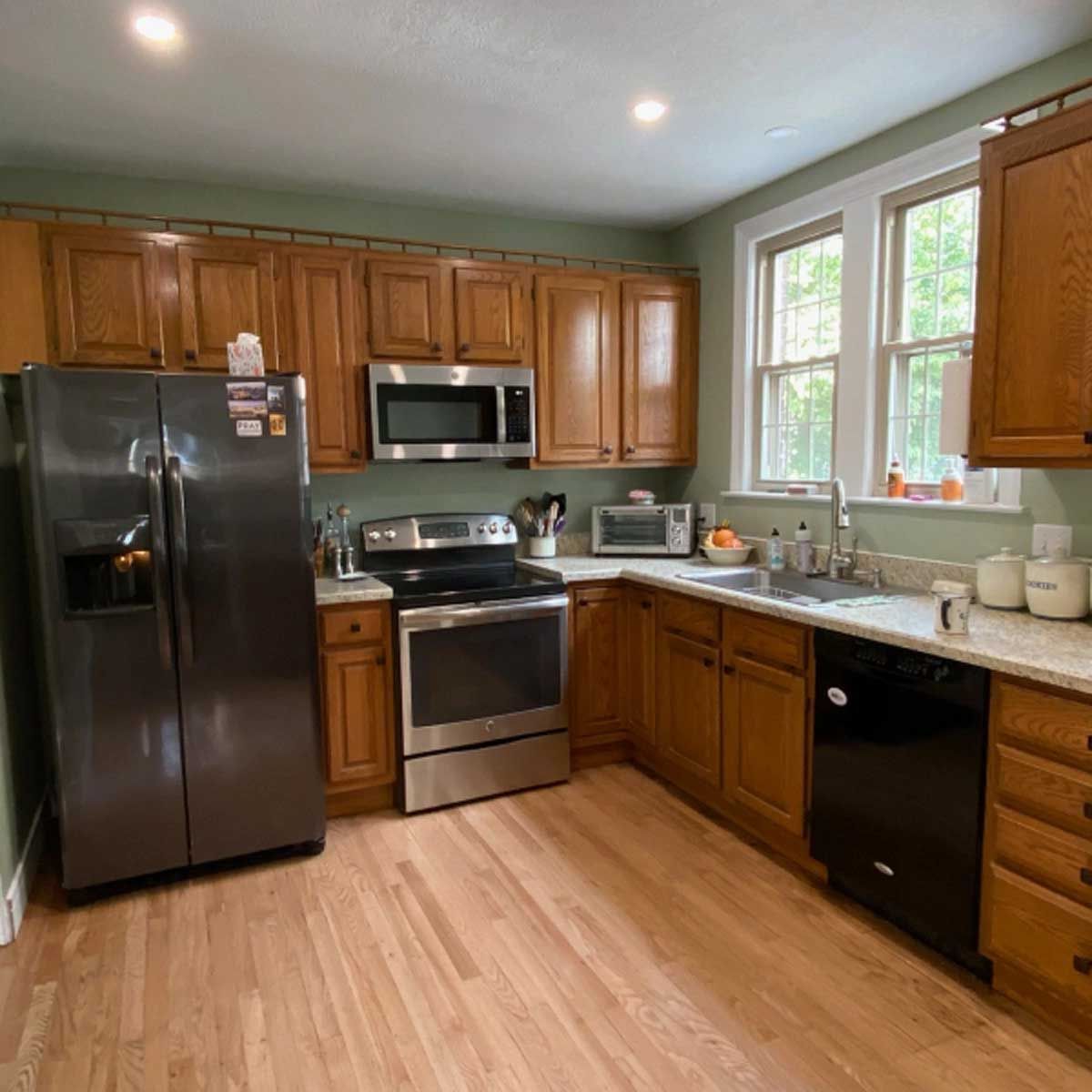 A kitchen with stainless steel appliances and wooden cabinets