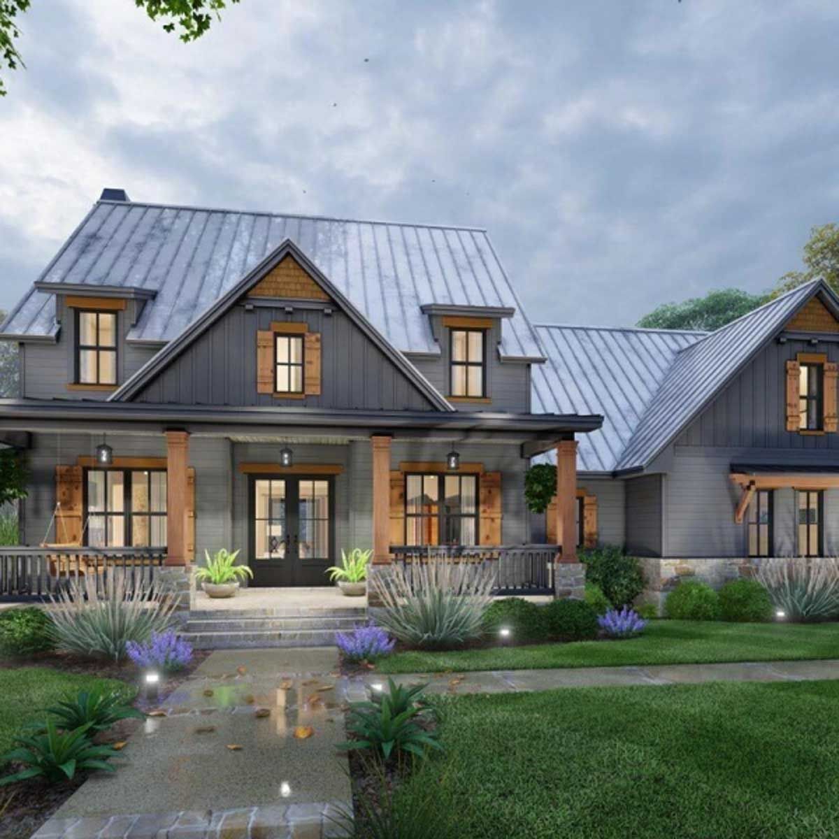 A large house with a metal roof and a large porch.