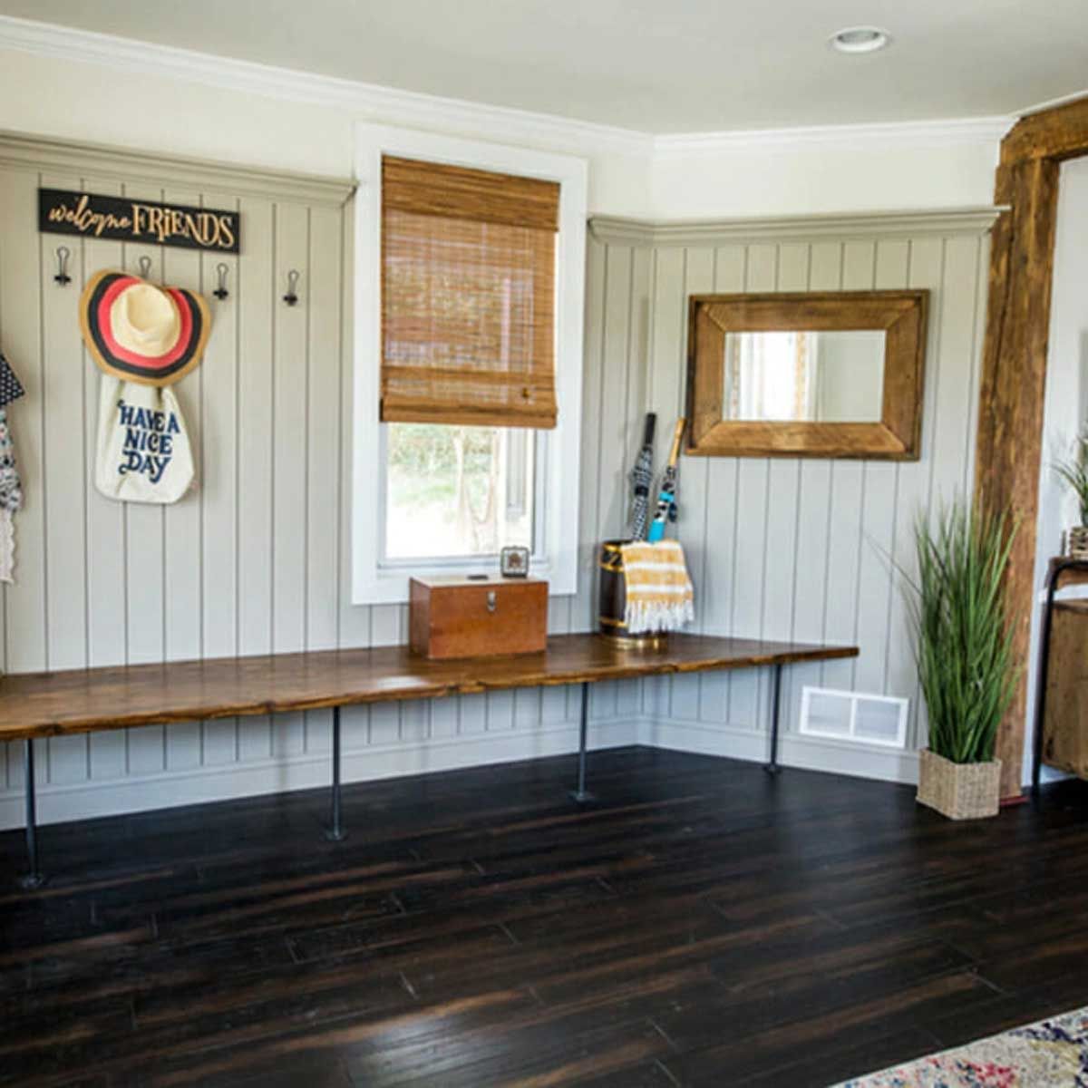 A room with a bench and a sign that says welcome friends
