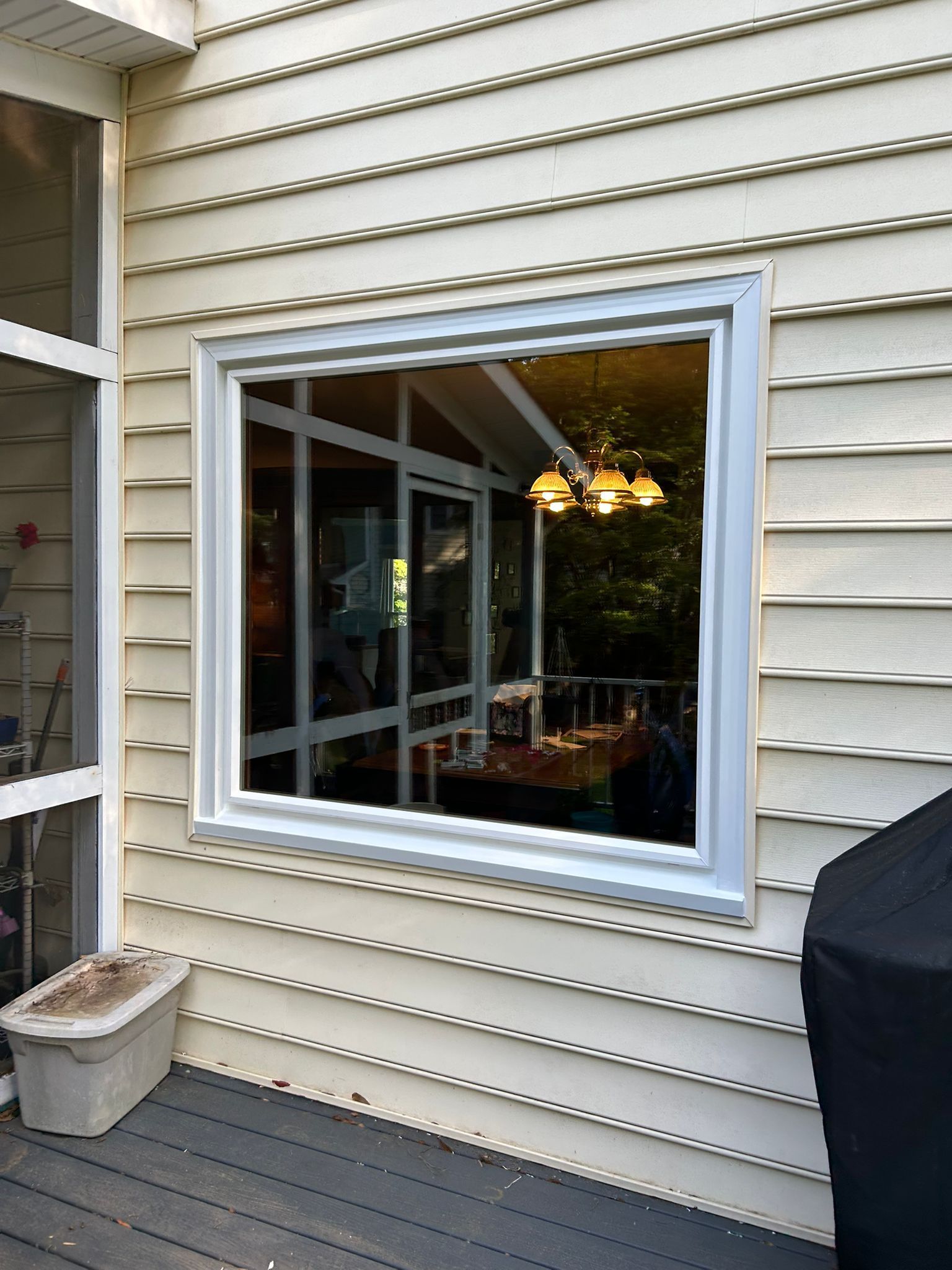 There is a large window on the side of a house.