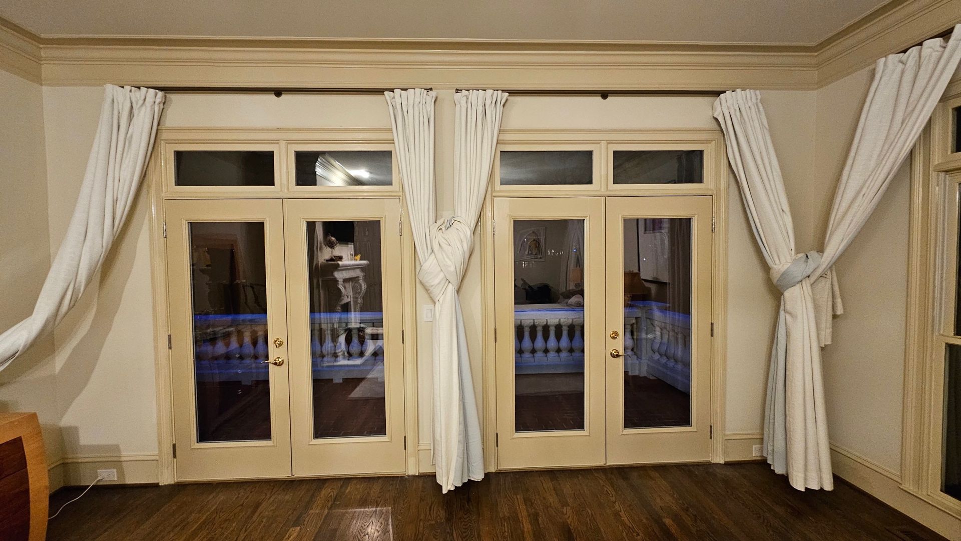 A living room with a lot of windows and curtains