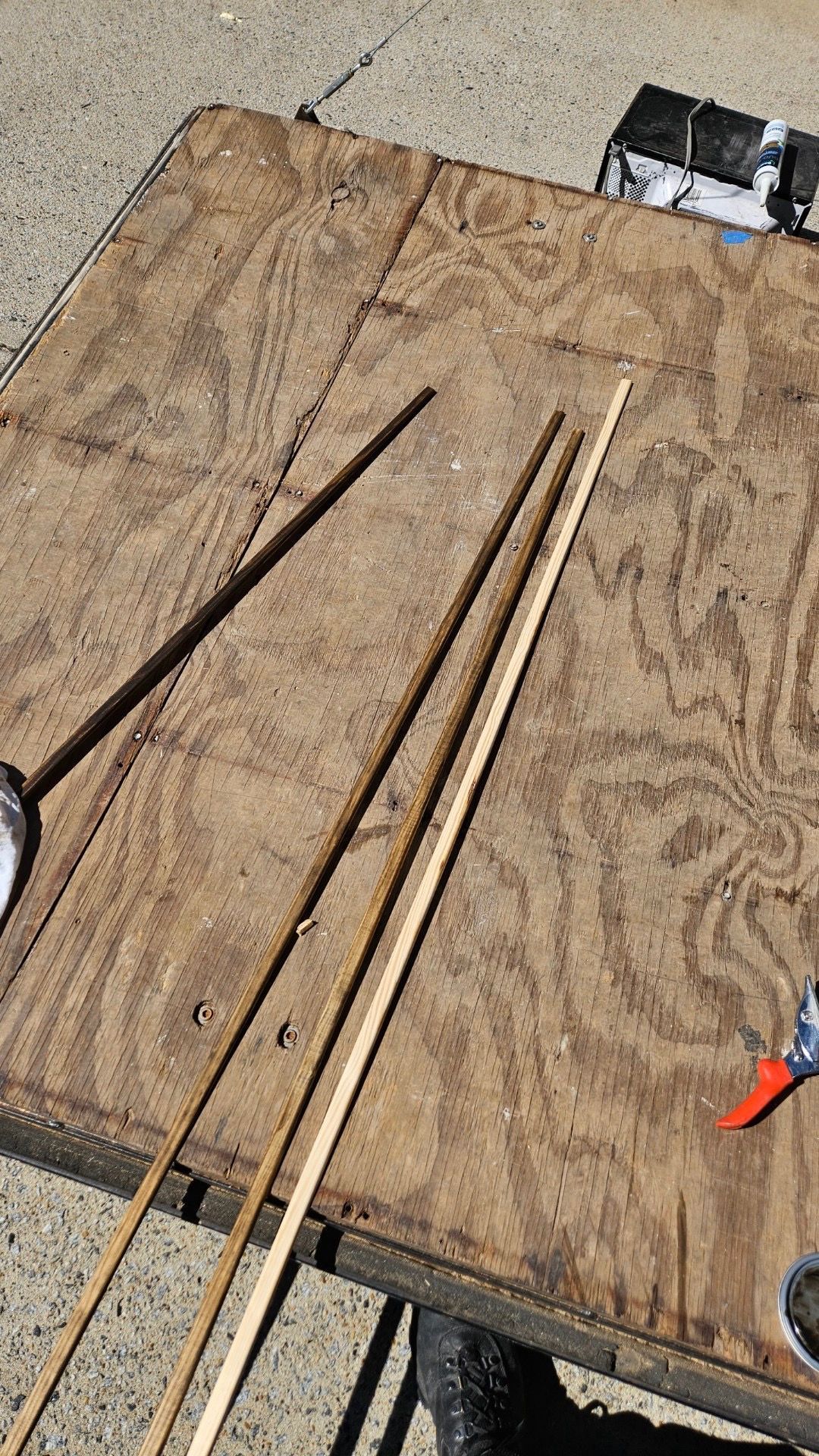 A wooden table with a bunch of sticks on it.