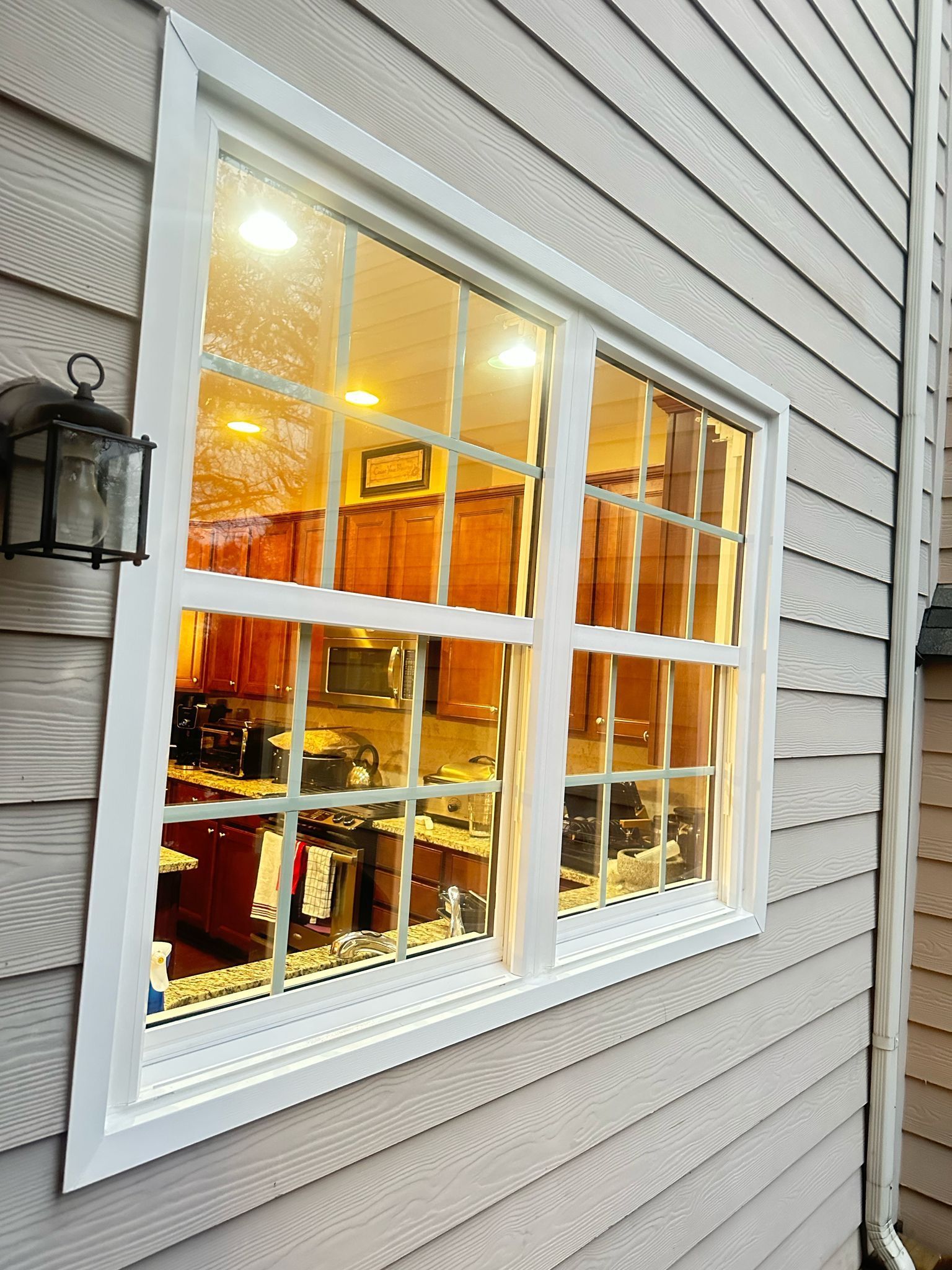 A large window on the side of a house looking out to a kitchen.