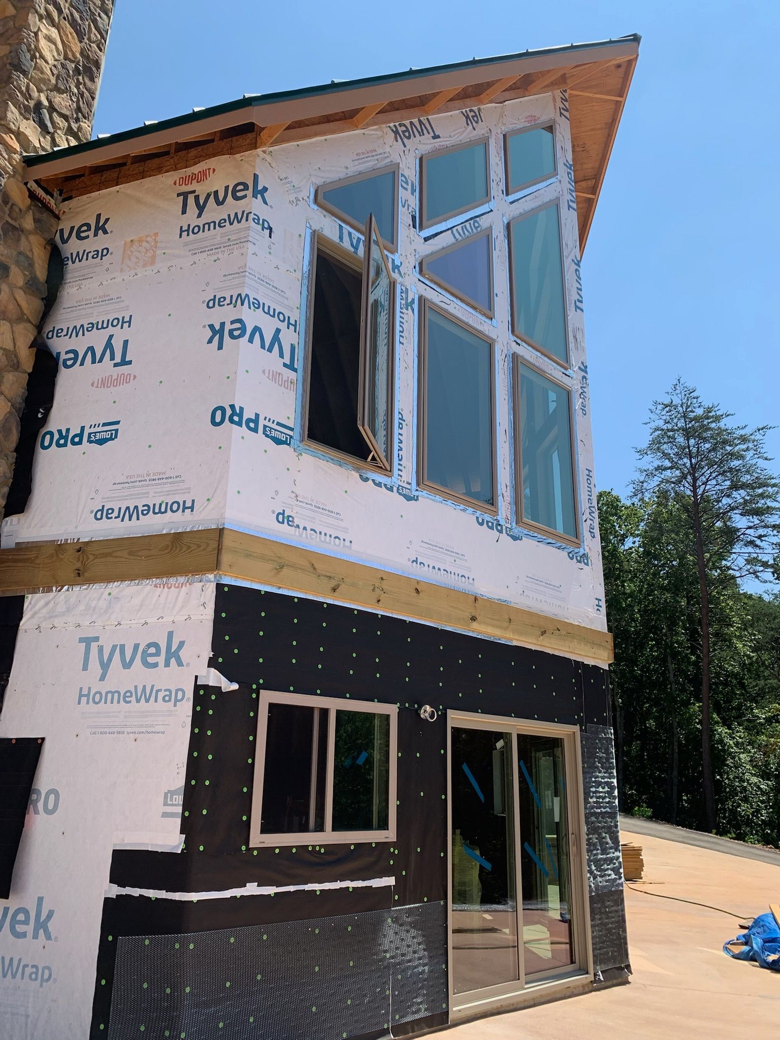 A building with a lot of windows is covered in tyvek insulation