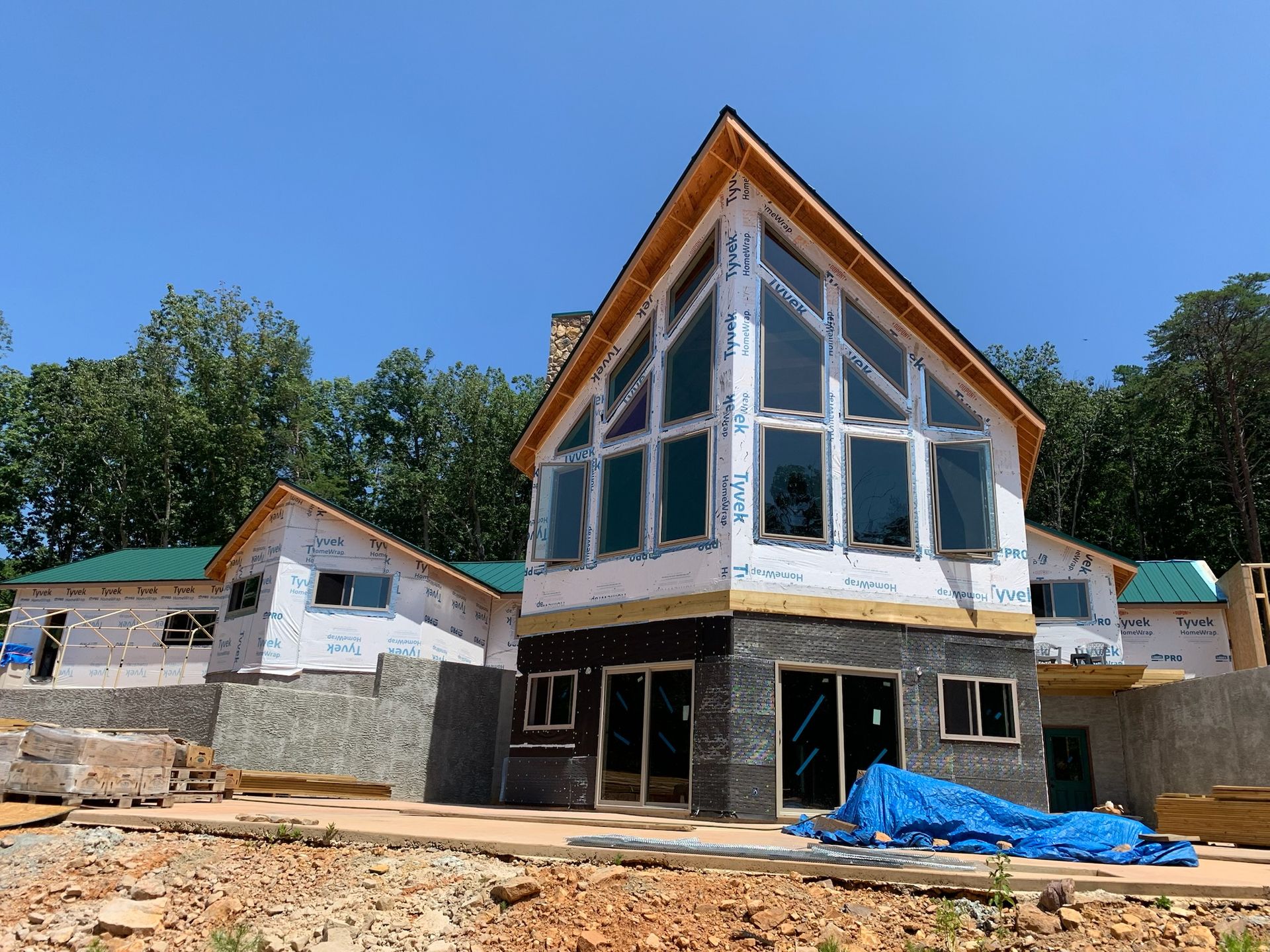 A house that is being built with a lot of windows
