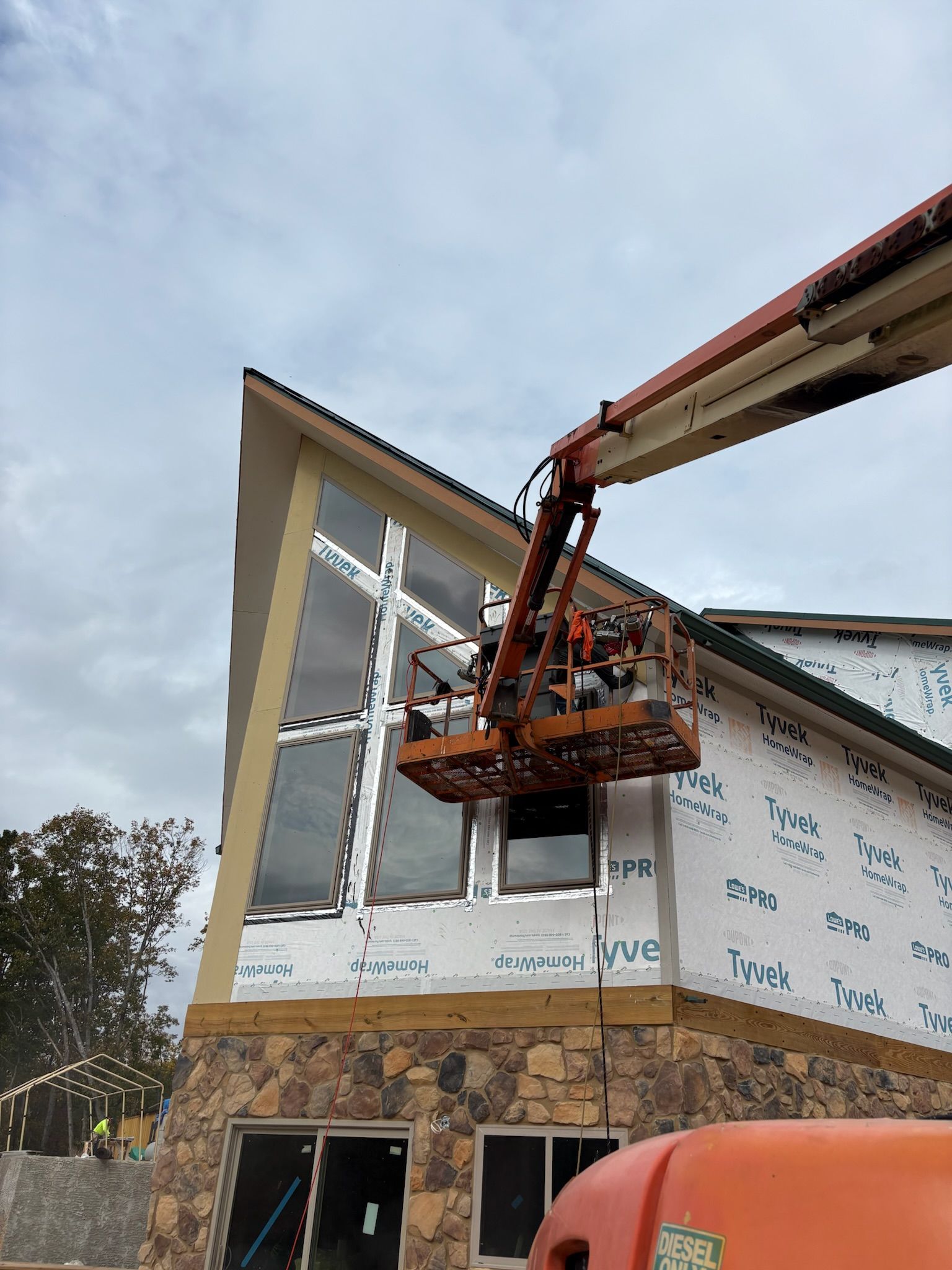 A group of people are working on a building with a crane.