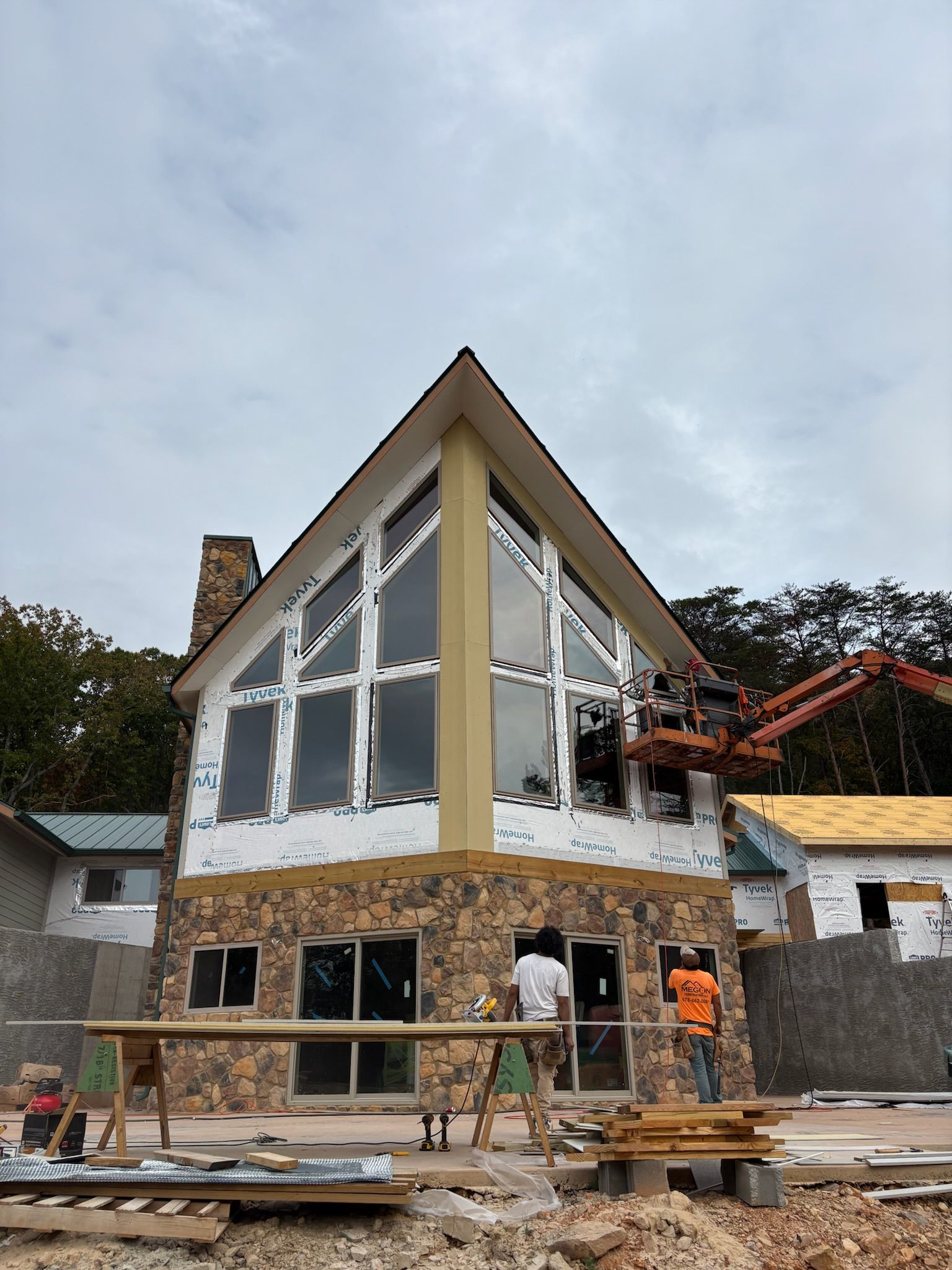A large house with a lot of windows is being built.