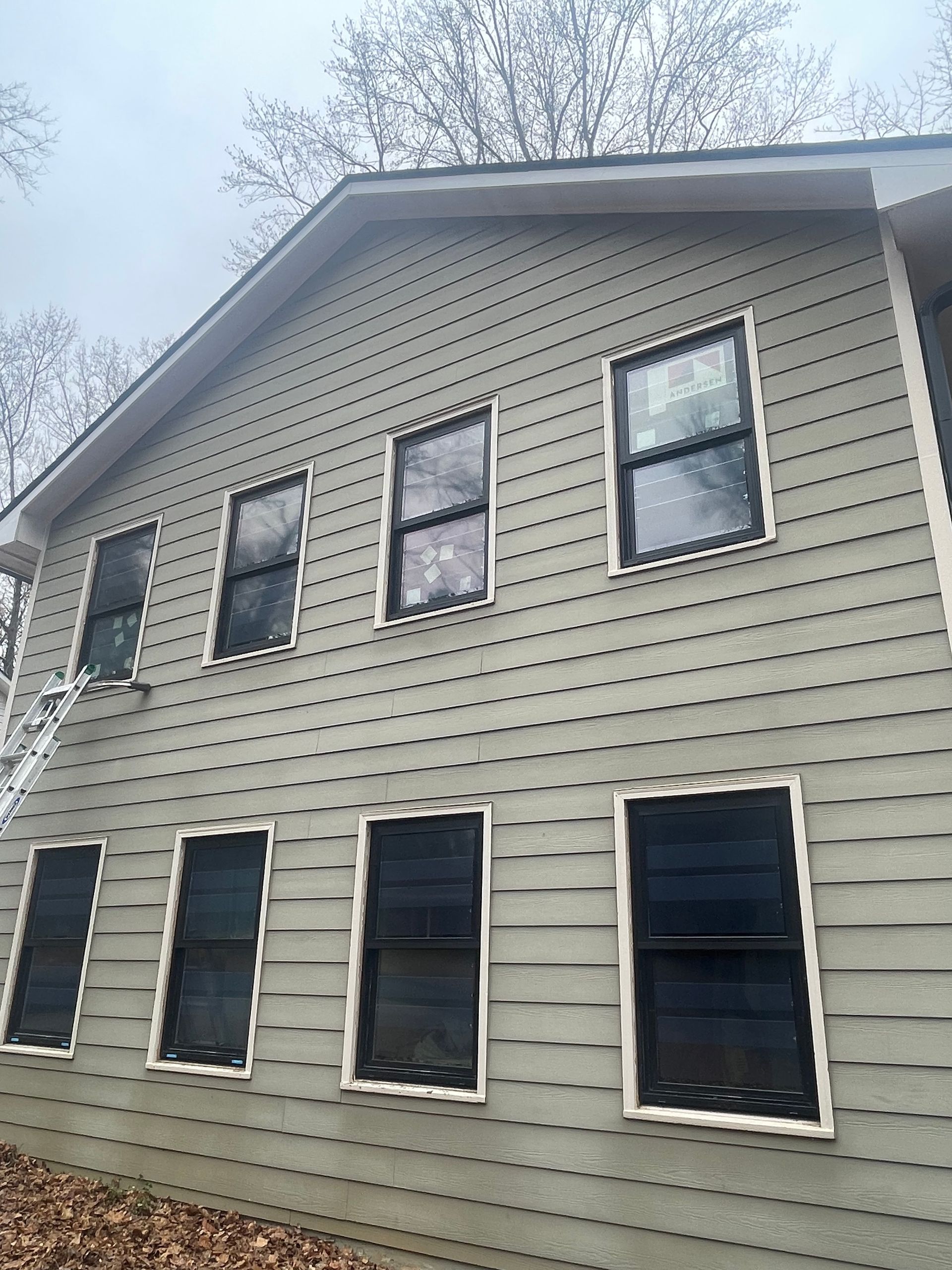 A large house with a lot of windows on the side of it.