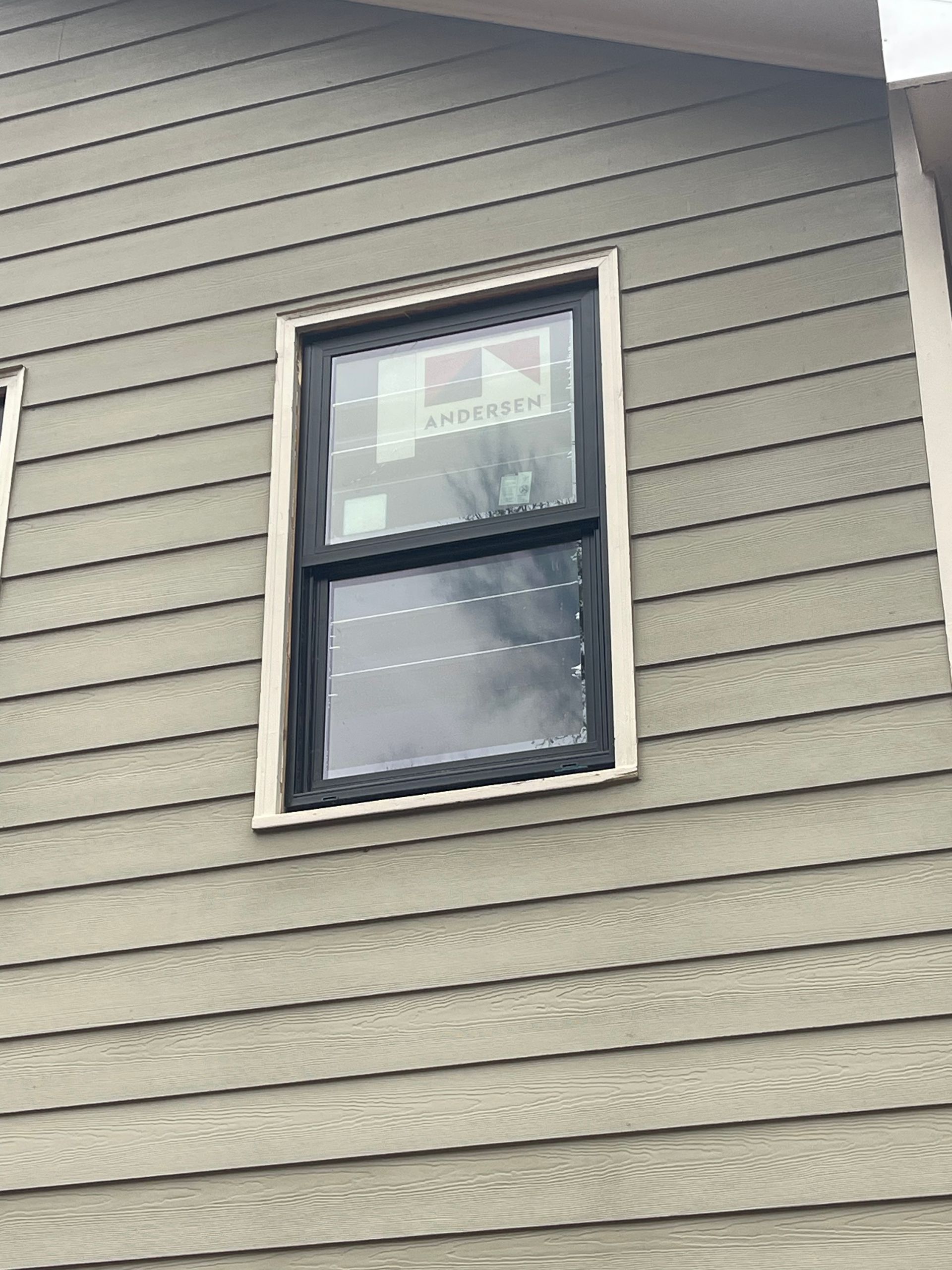 A close up of a window on the side of a house.