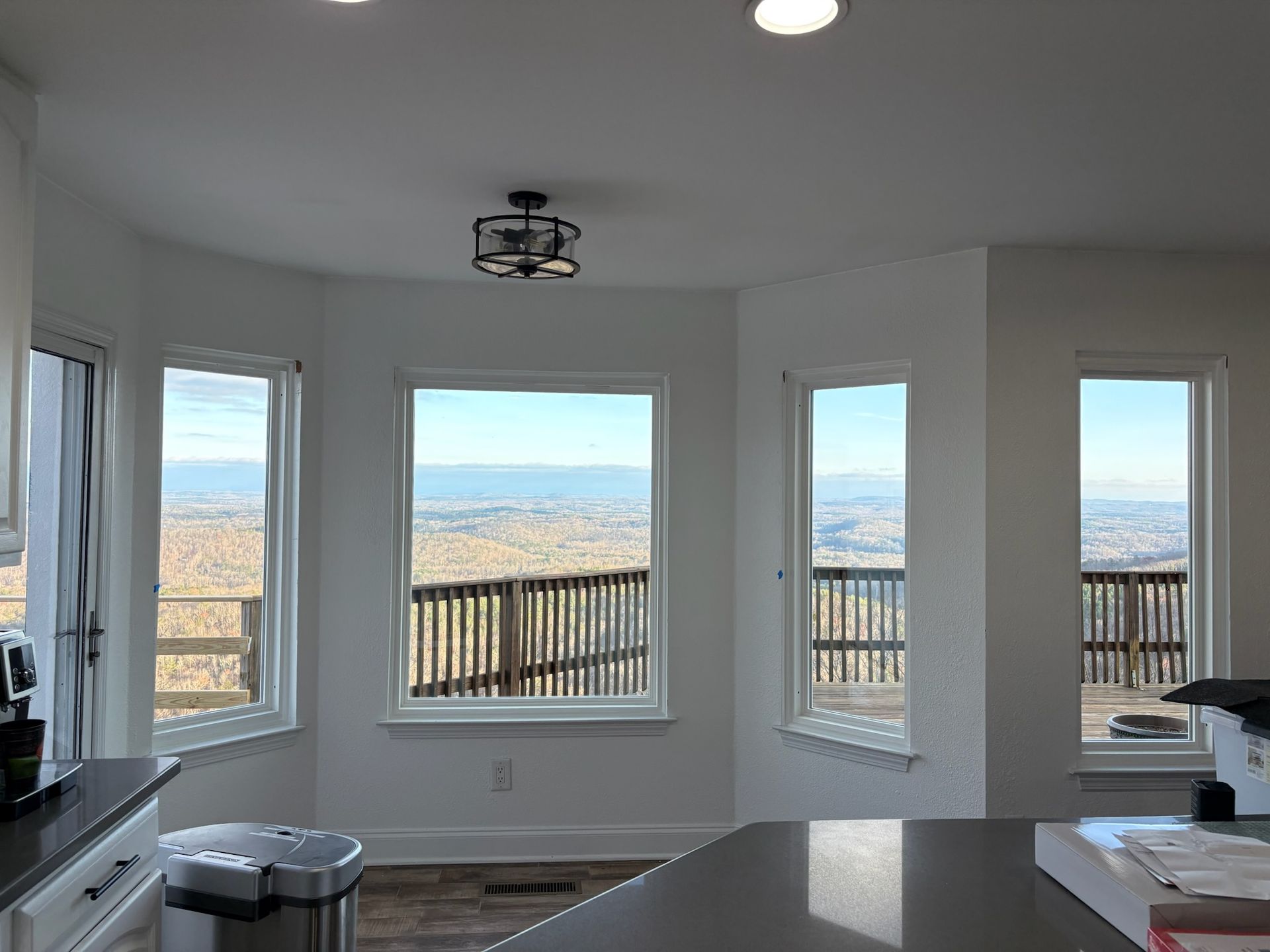 A kitchen with a lot of windows and a view of the mountains.