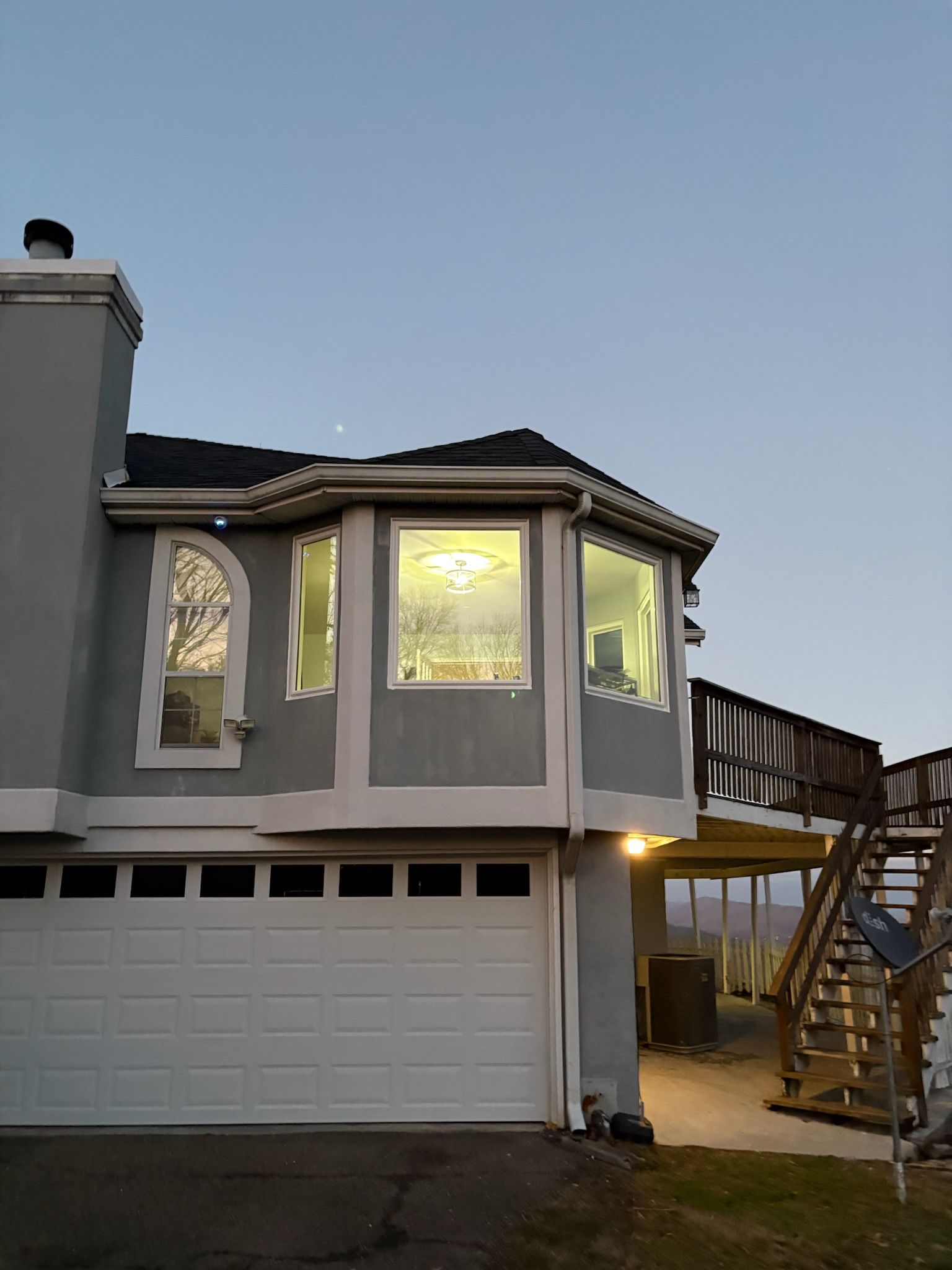 A house with a garage and stairs on the side of it