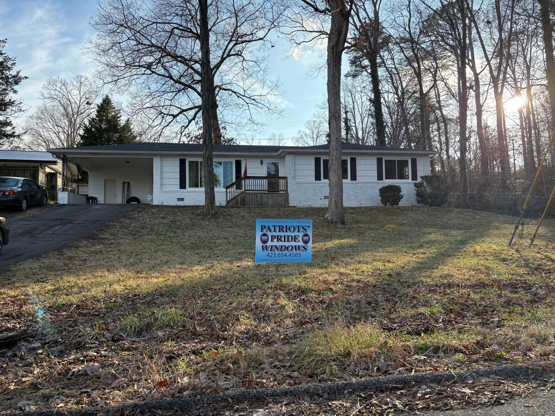 A house with a for sale sign in front of it.