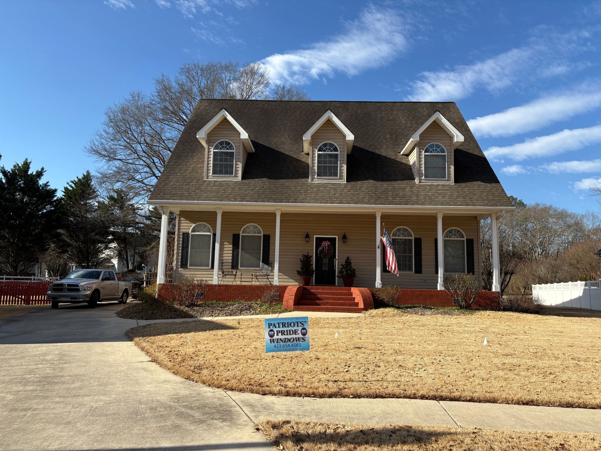 A house with a sign in front of it that says 