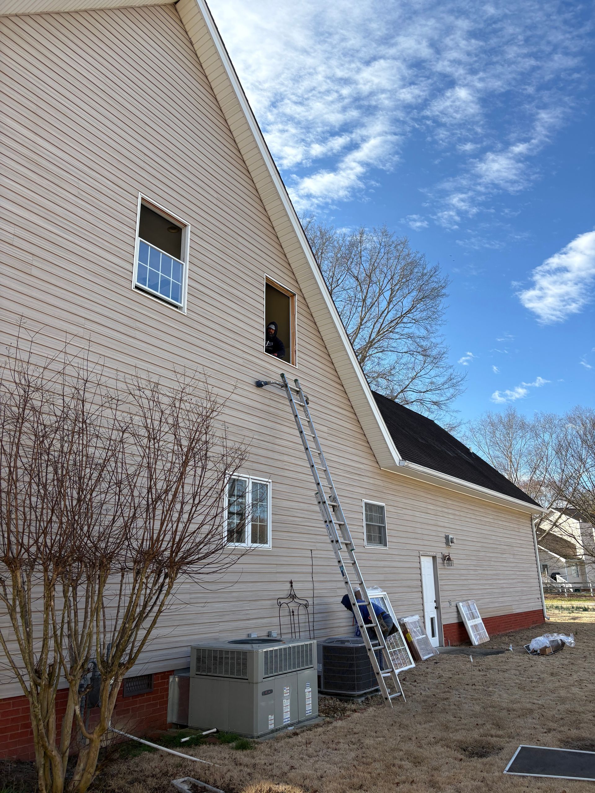 A house with a ladder attached to the side of it.