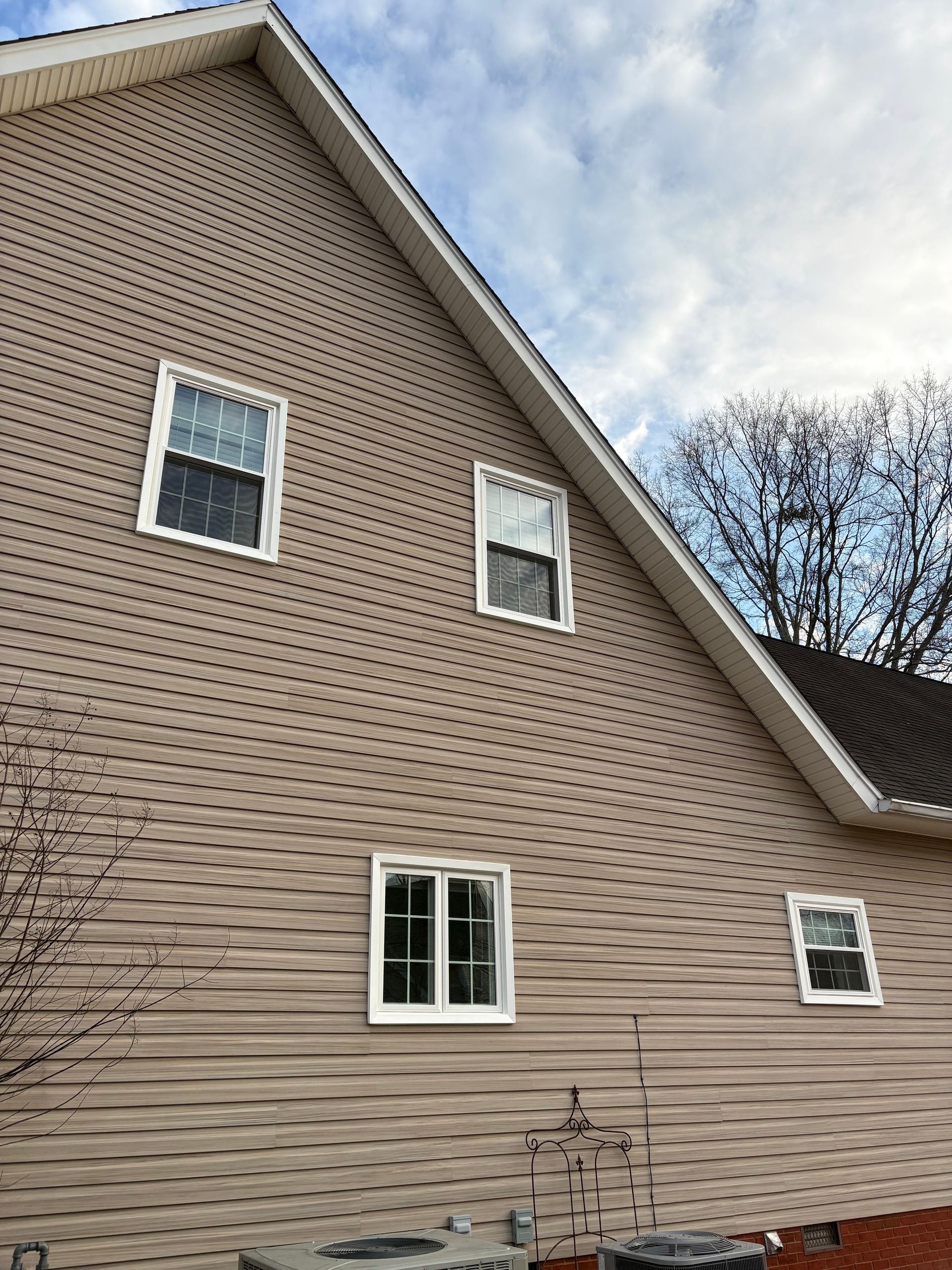 A house with a lot of windows on the side of it.