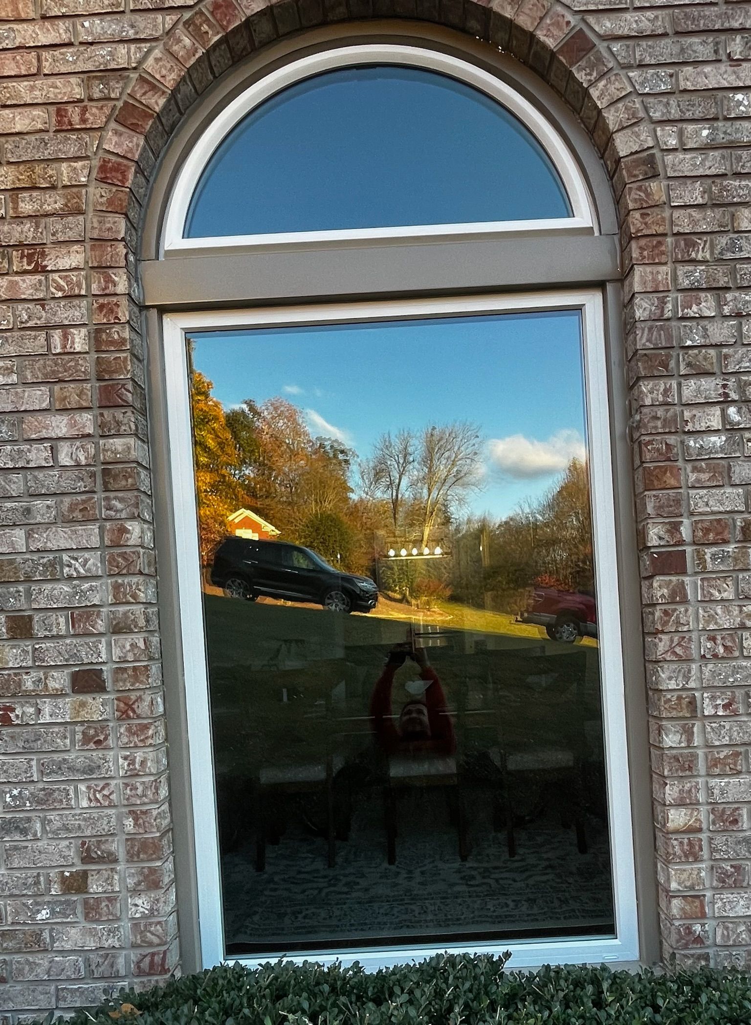 A large arched window on a brick building