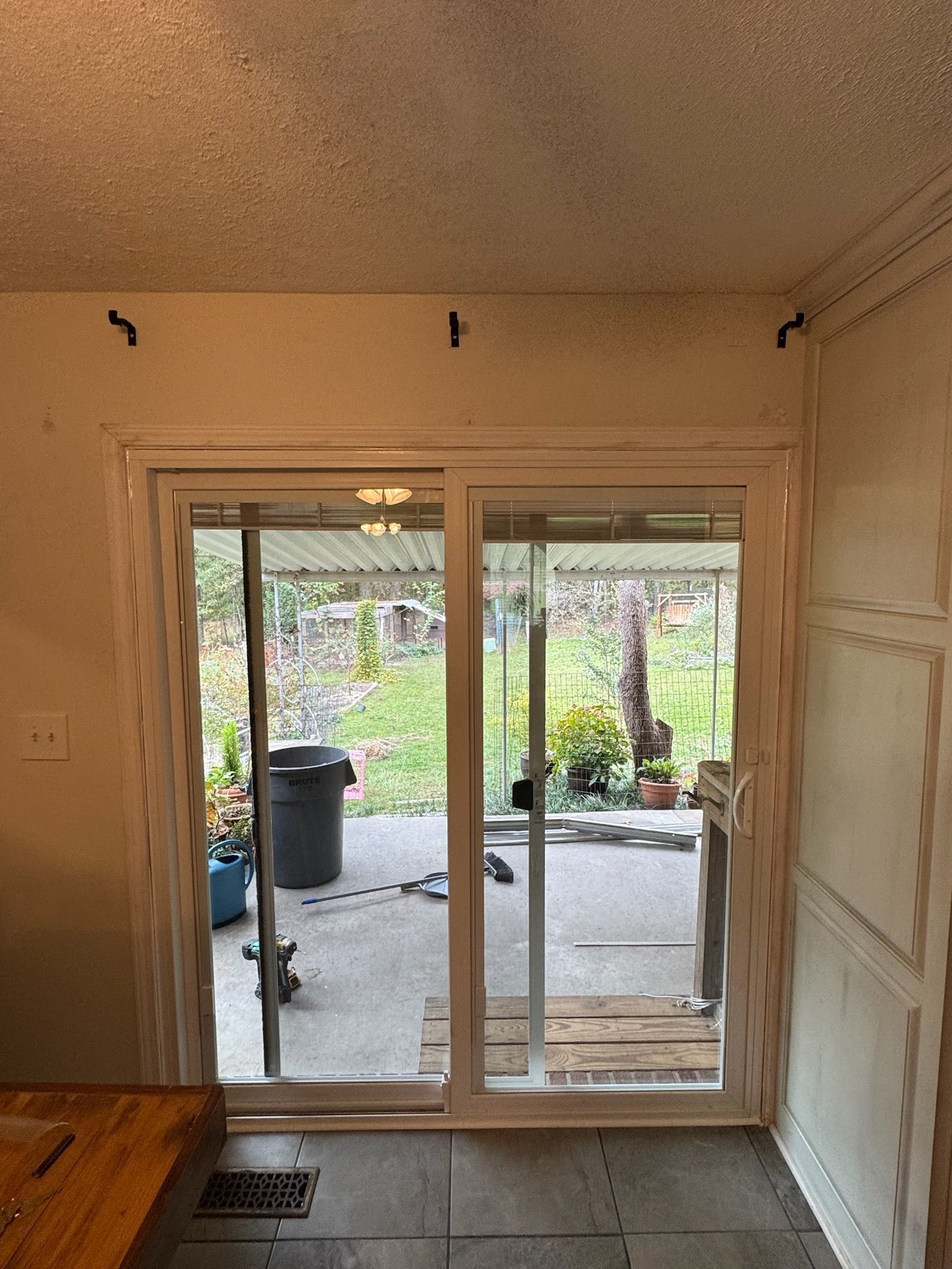 A kitchen with a sliding glass door leading to a patio.