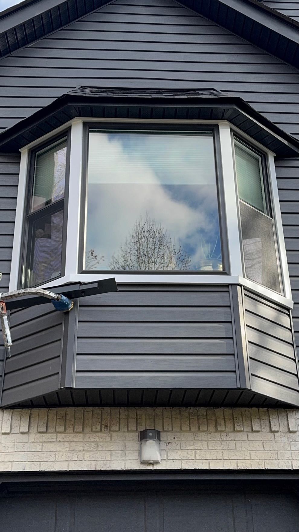 A large bay window on the side of a house.