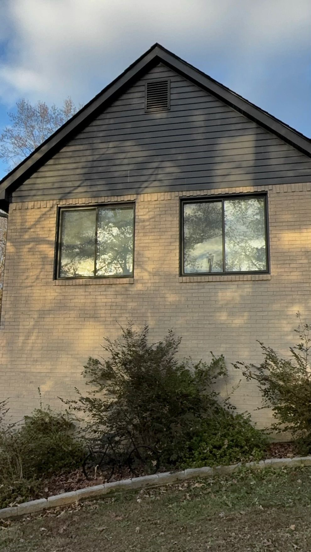 A house with a black roof and a lot of windows