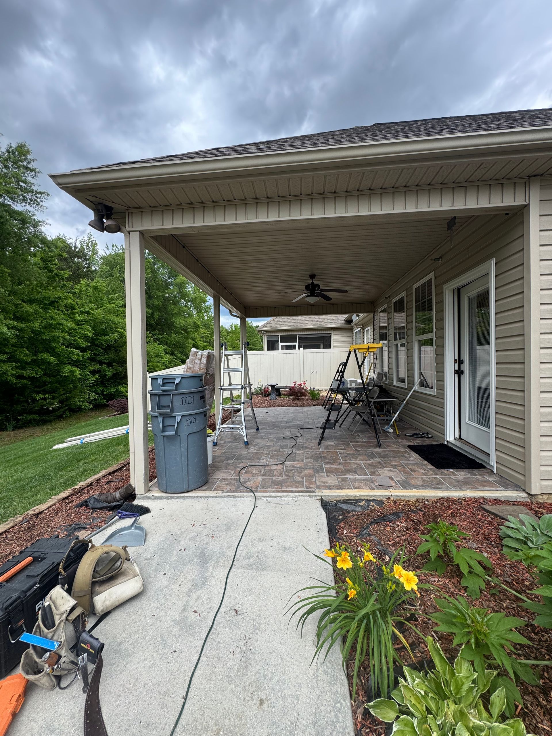 A house with a covered patio in front of it.