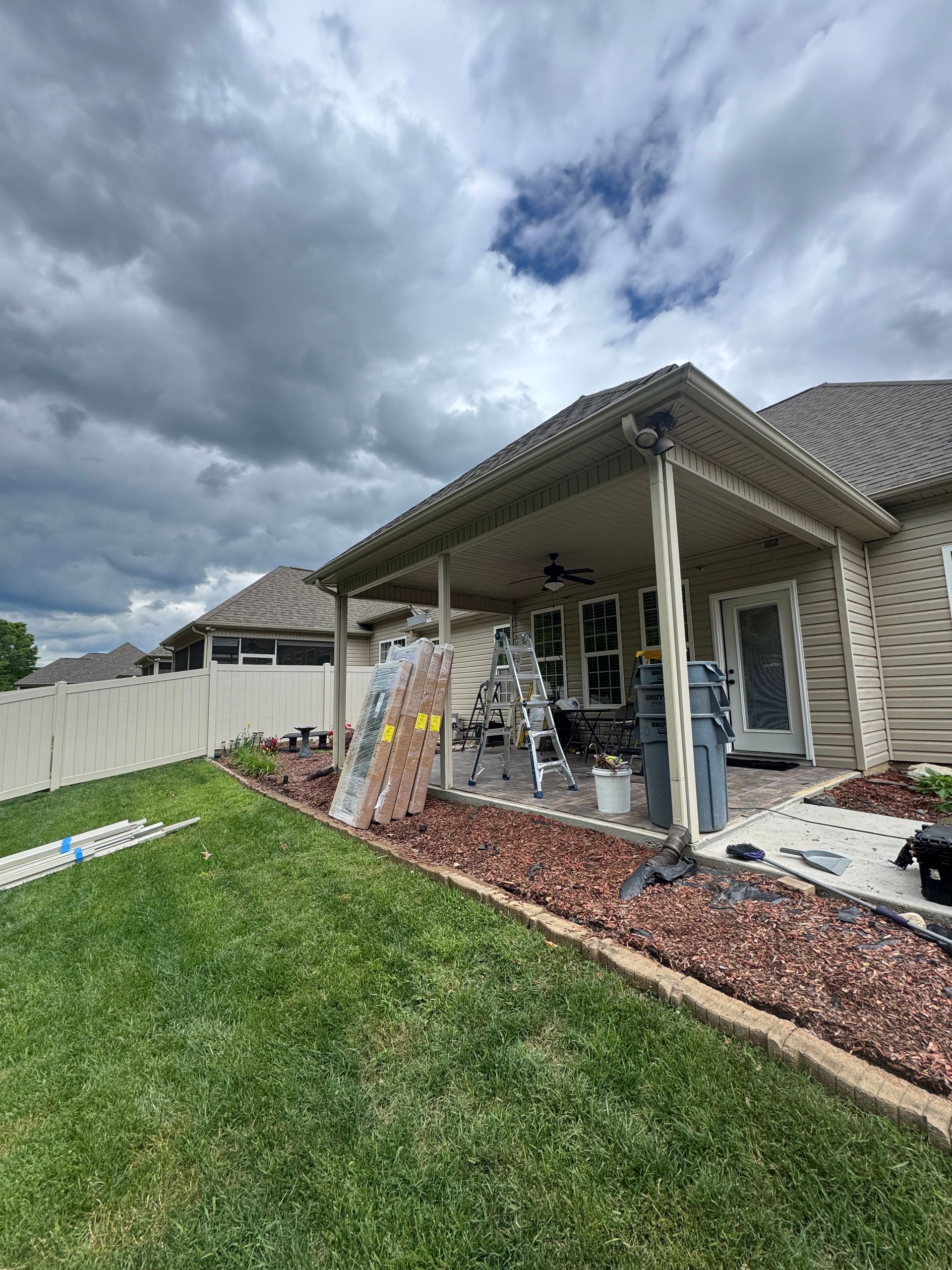 A house with a covered patio in the backyard under construction.