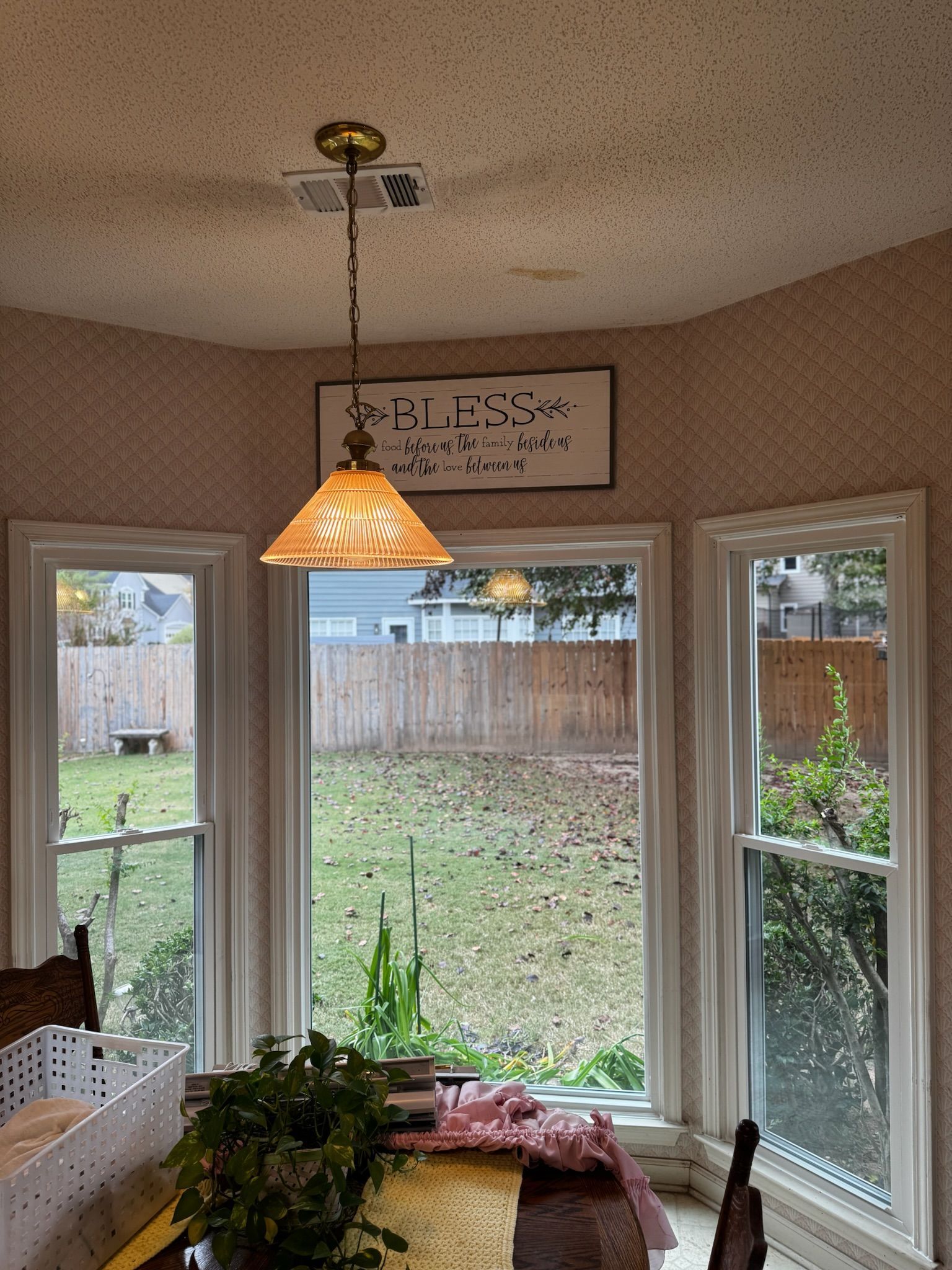 A dining room with a sign on the wall that says 