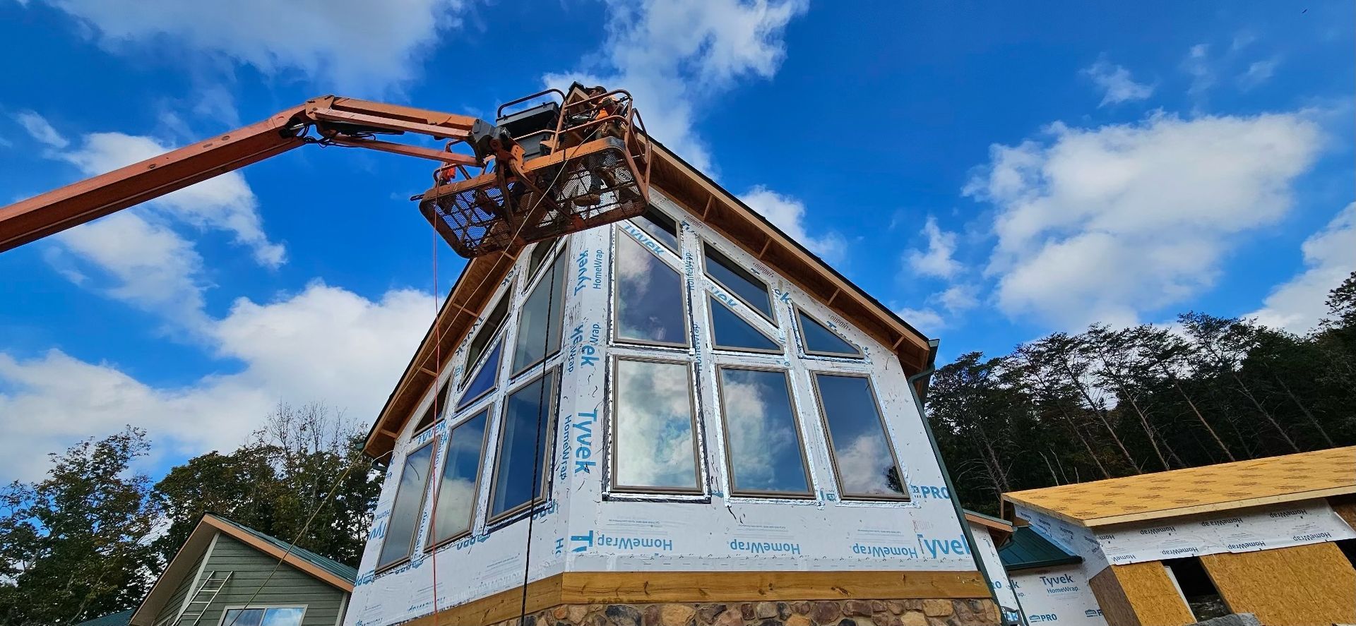 A large house is being built with a crane on top of it.
