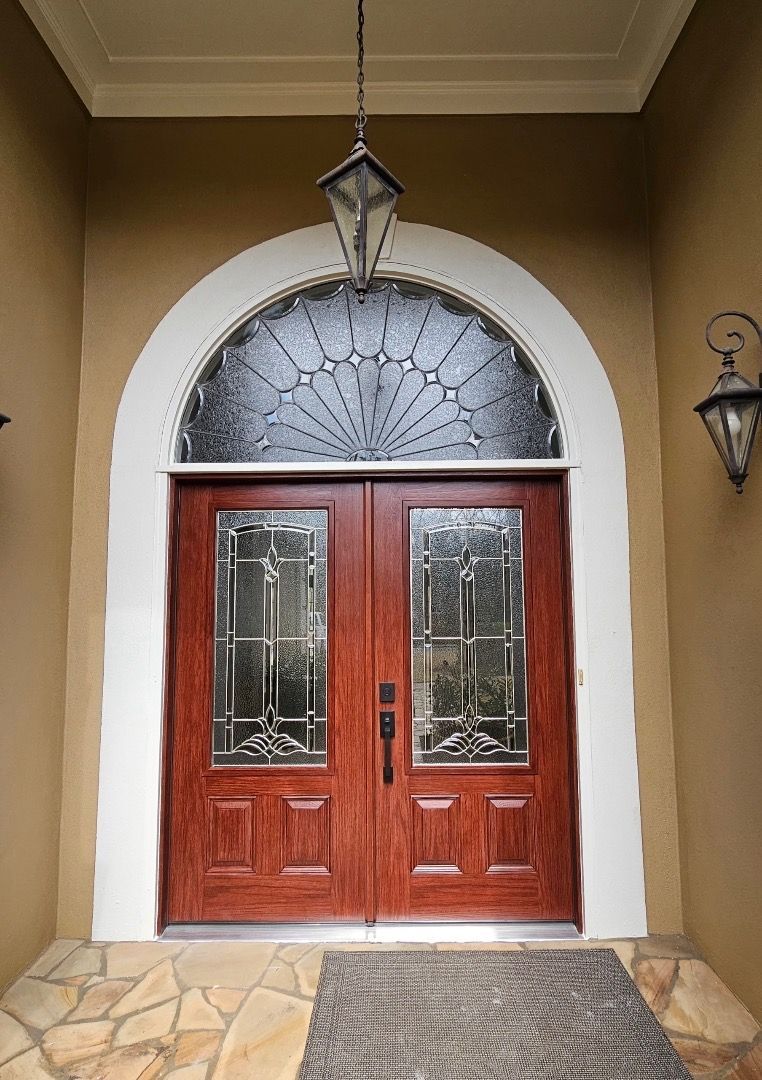 The front door of a house with a lantern hanging from the ceiling.