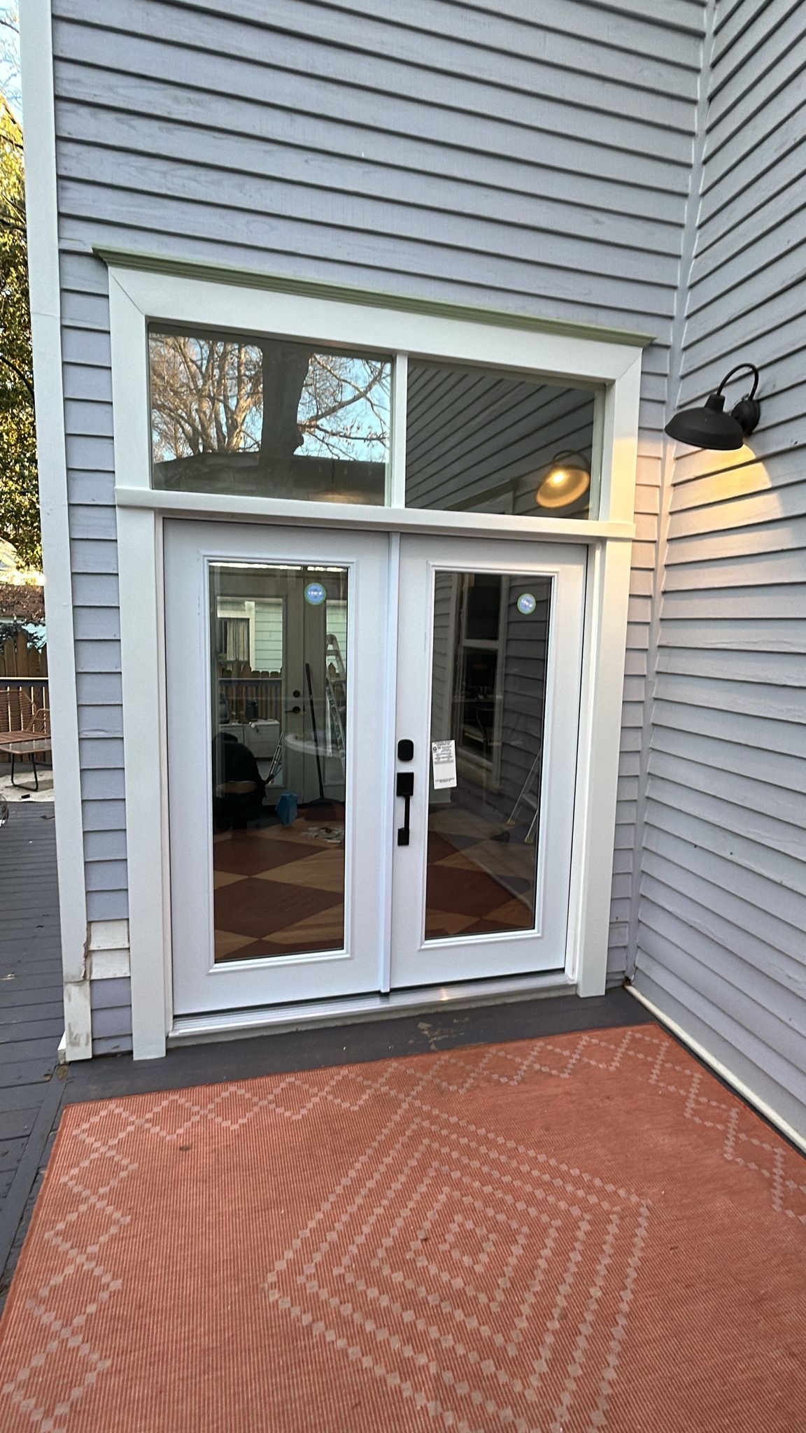 A white door with a window on the side of a house.