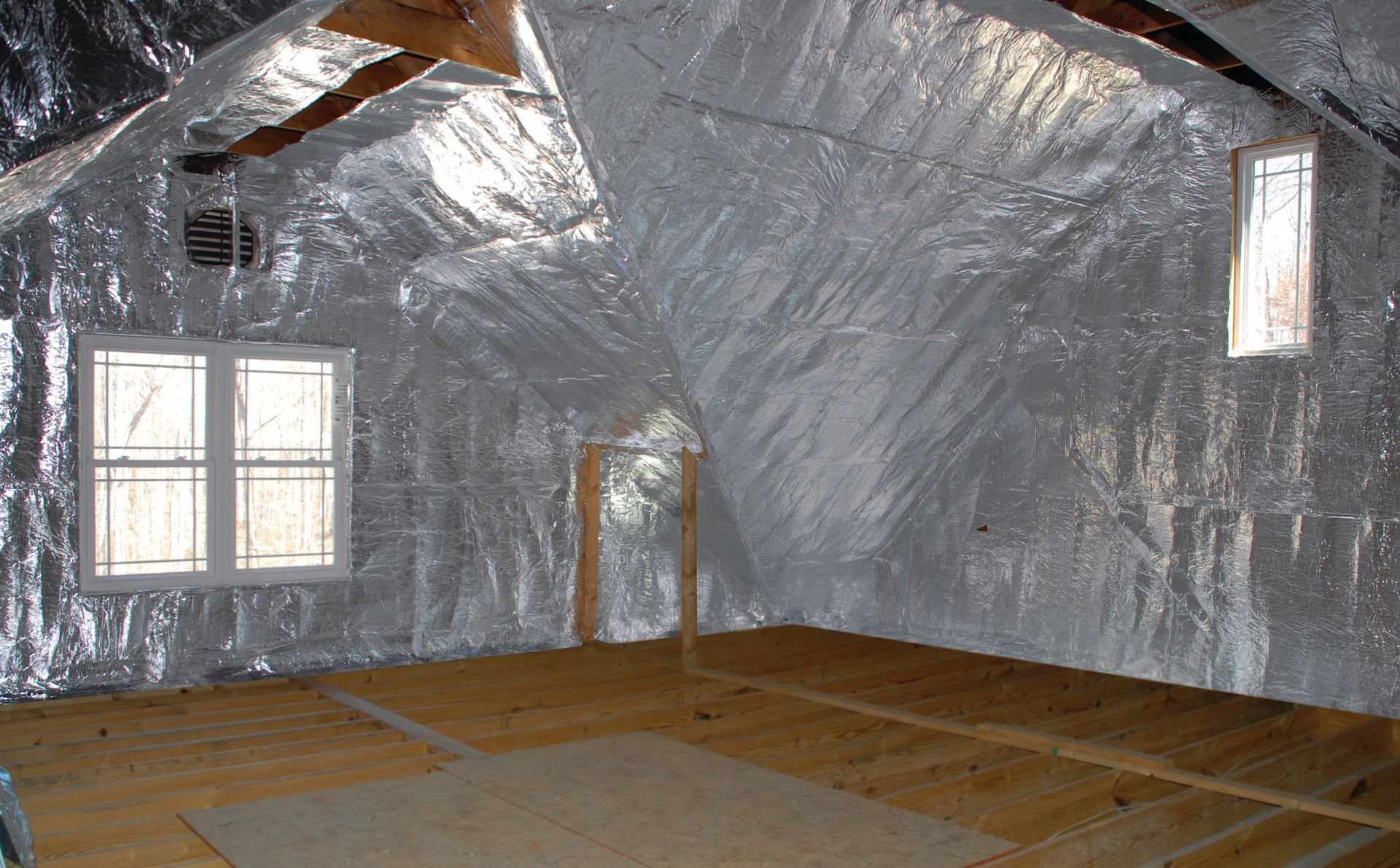 An attic with aluminum foil on the walls and ceiling