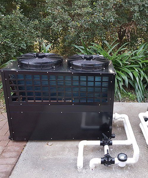 A Black Colored Heat Pump Engine — Pool Heat Pumps in Gympie, QLD