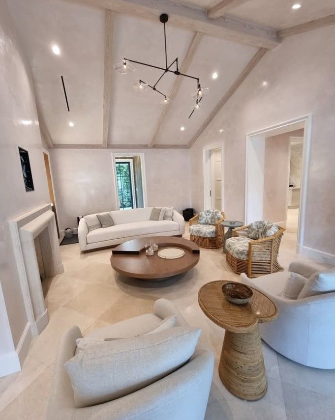 Living room with light-colored walls, vaulted ceiling, and modern furniture.