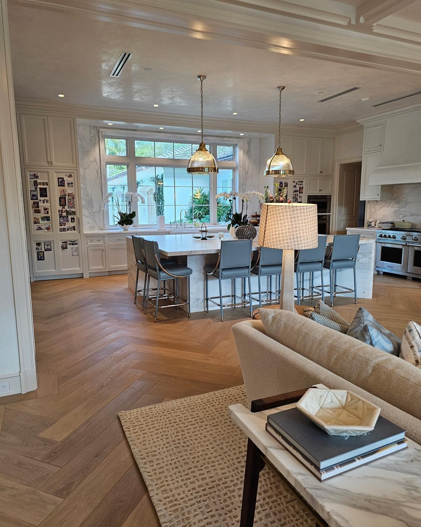 Elegant kitchen with island, bar stools, and hardwood floors.