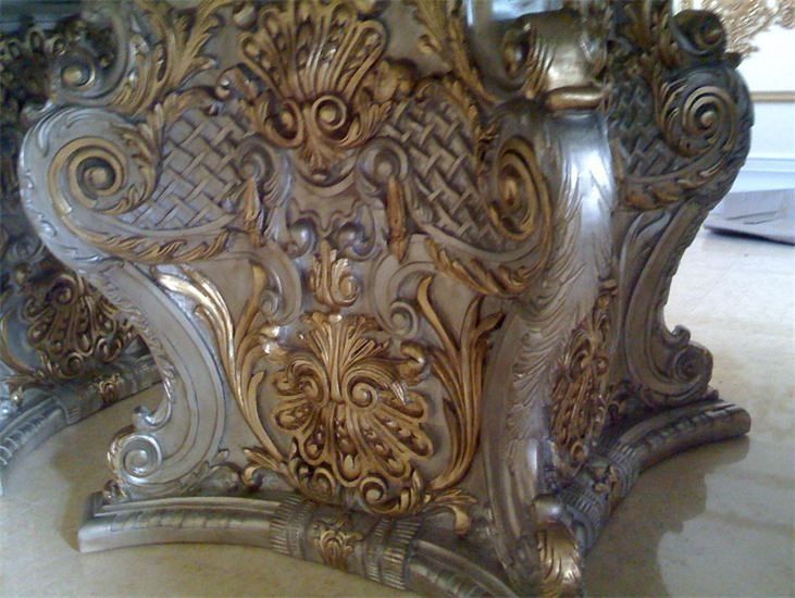 Ornate, silver and gold carved table base.