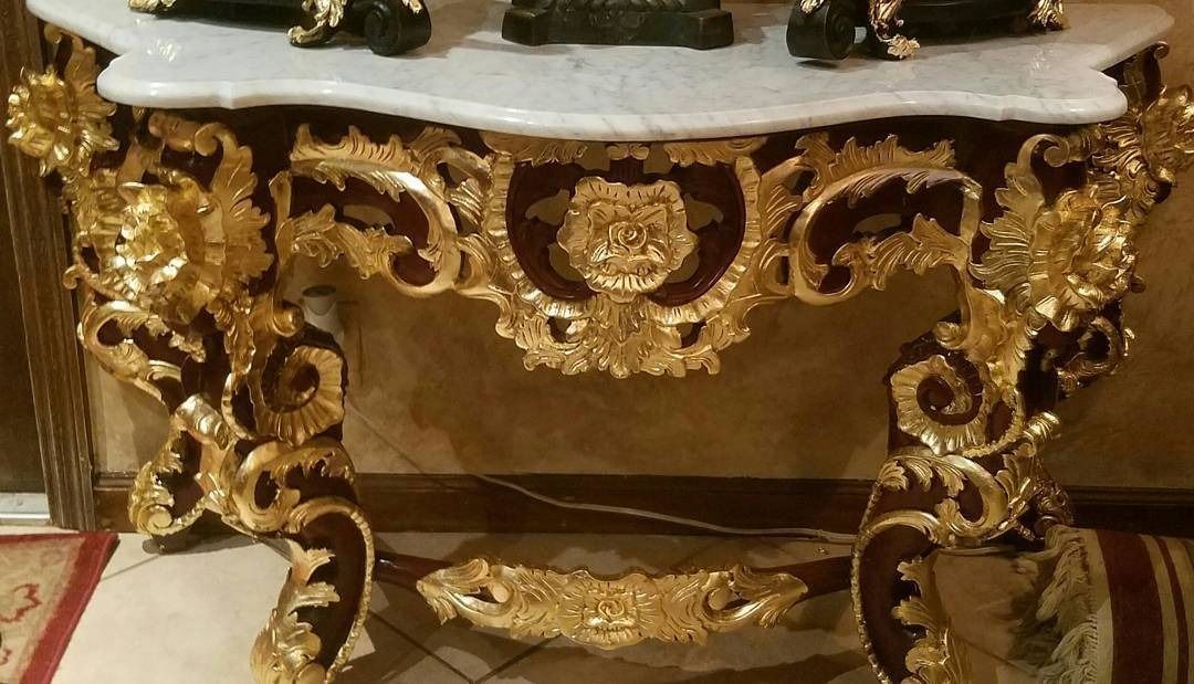 Ornate gilded and mahogany console table with marble top.