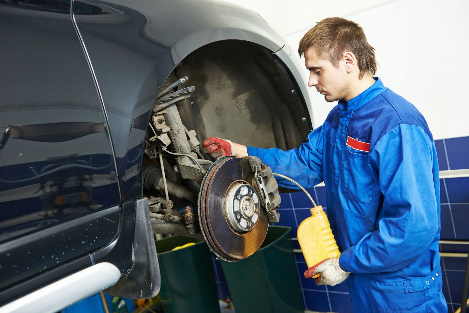 An experienced technician working on a car brake repair in San Diego, CA.