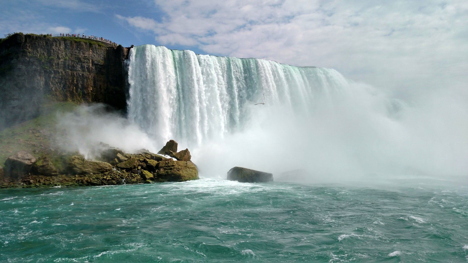 A waterfall is falling into a body of water.