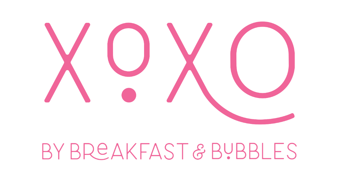 The logo for XOXO by Breakfast and Bubbles is pink and white.