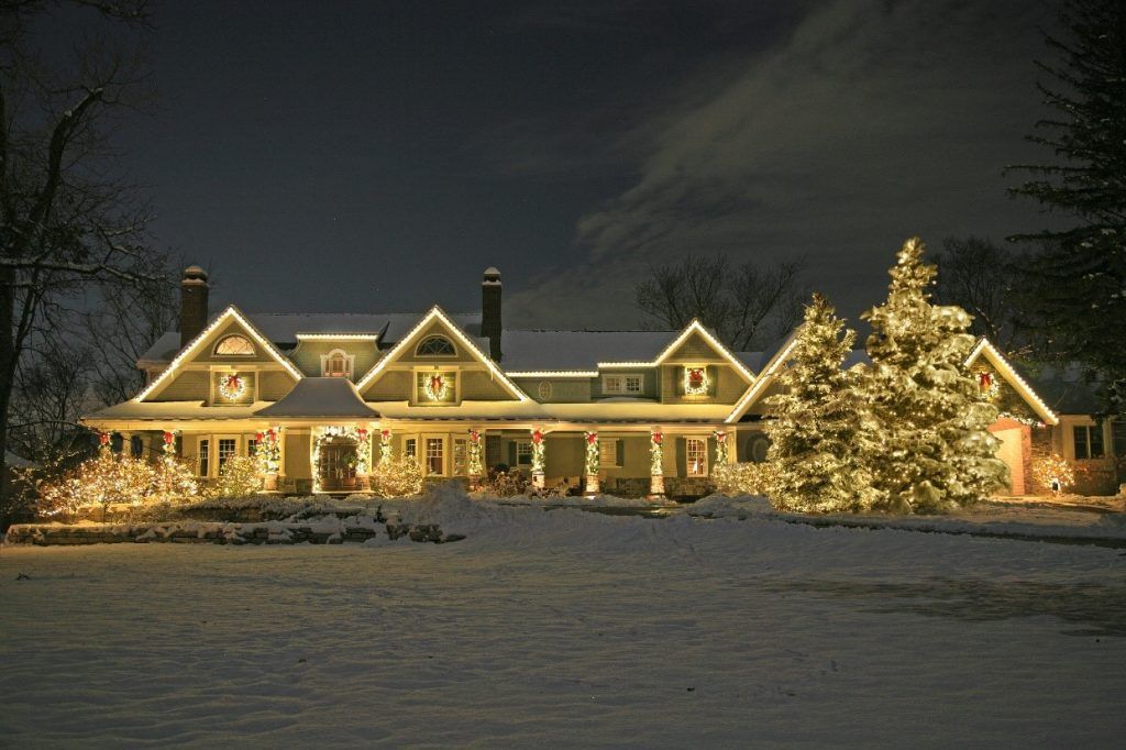 A large house with a christmas tree in front of it