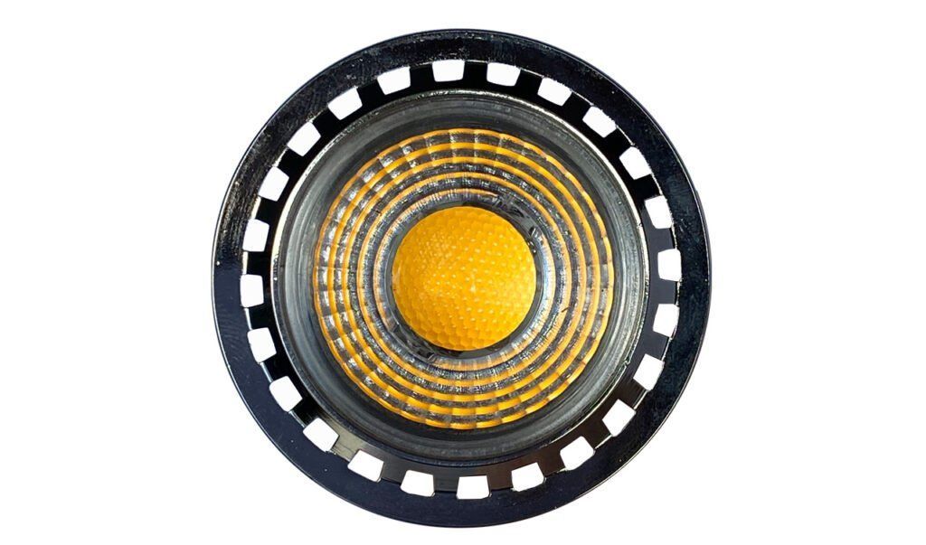 A close up of a speaker with a yellow center on a white background.